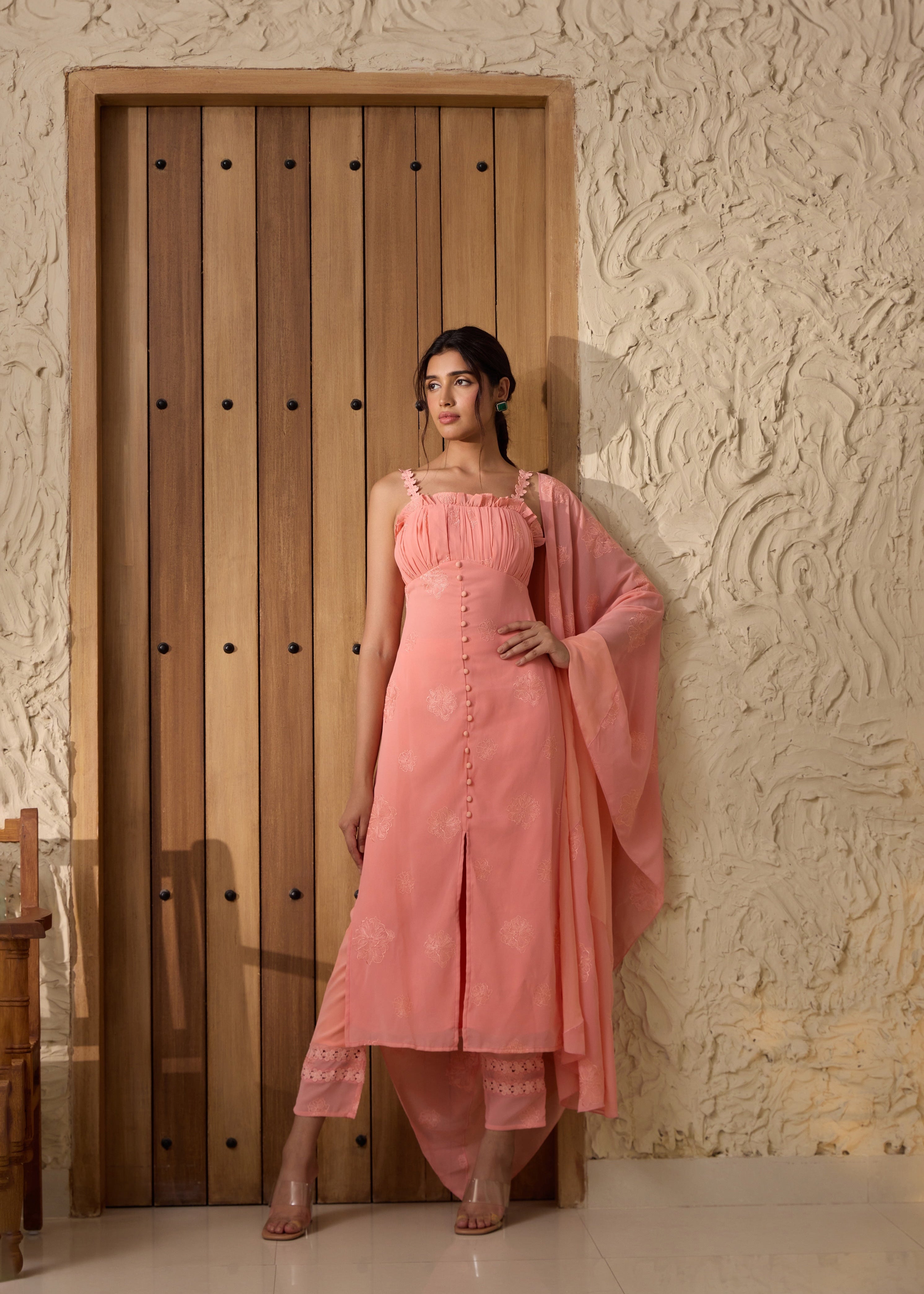 A pink georgette kurta set with intricate embroidery.