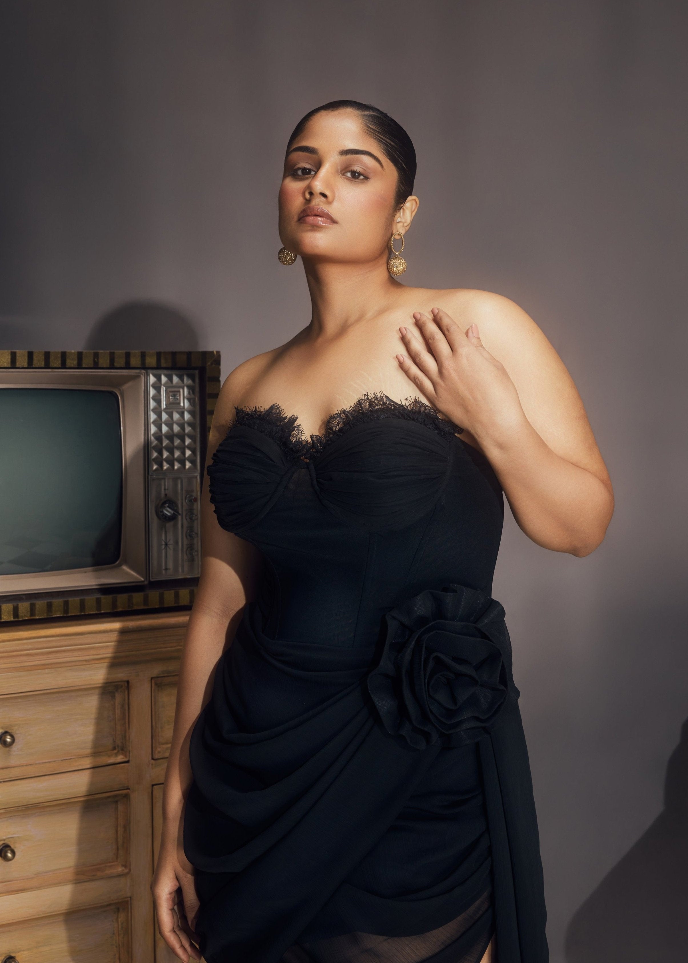 Abba Black Chiffon Strapless Rose Embellished Asymmetrical Midi Bustier Dress, featuring delicate rose details and a stylish asymmetrical hemline.