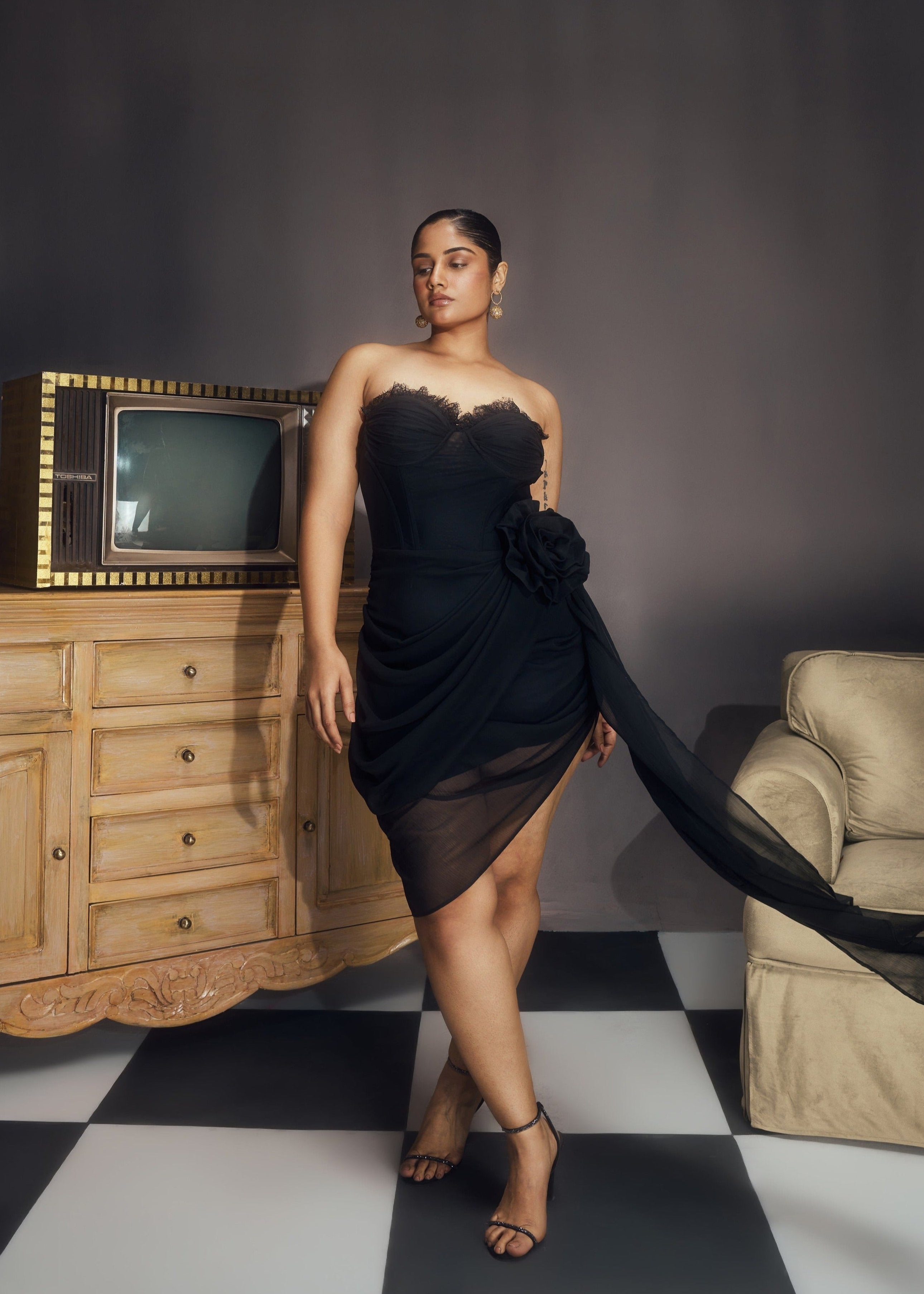 Abba Black Chiffon Strapless Rose Embellished Asymmetrical Midi Bustier Dress, featuring delicate rose details and a stylish asymmetrical hemline.