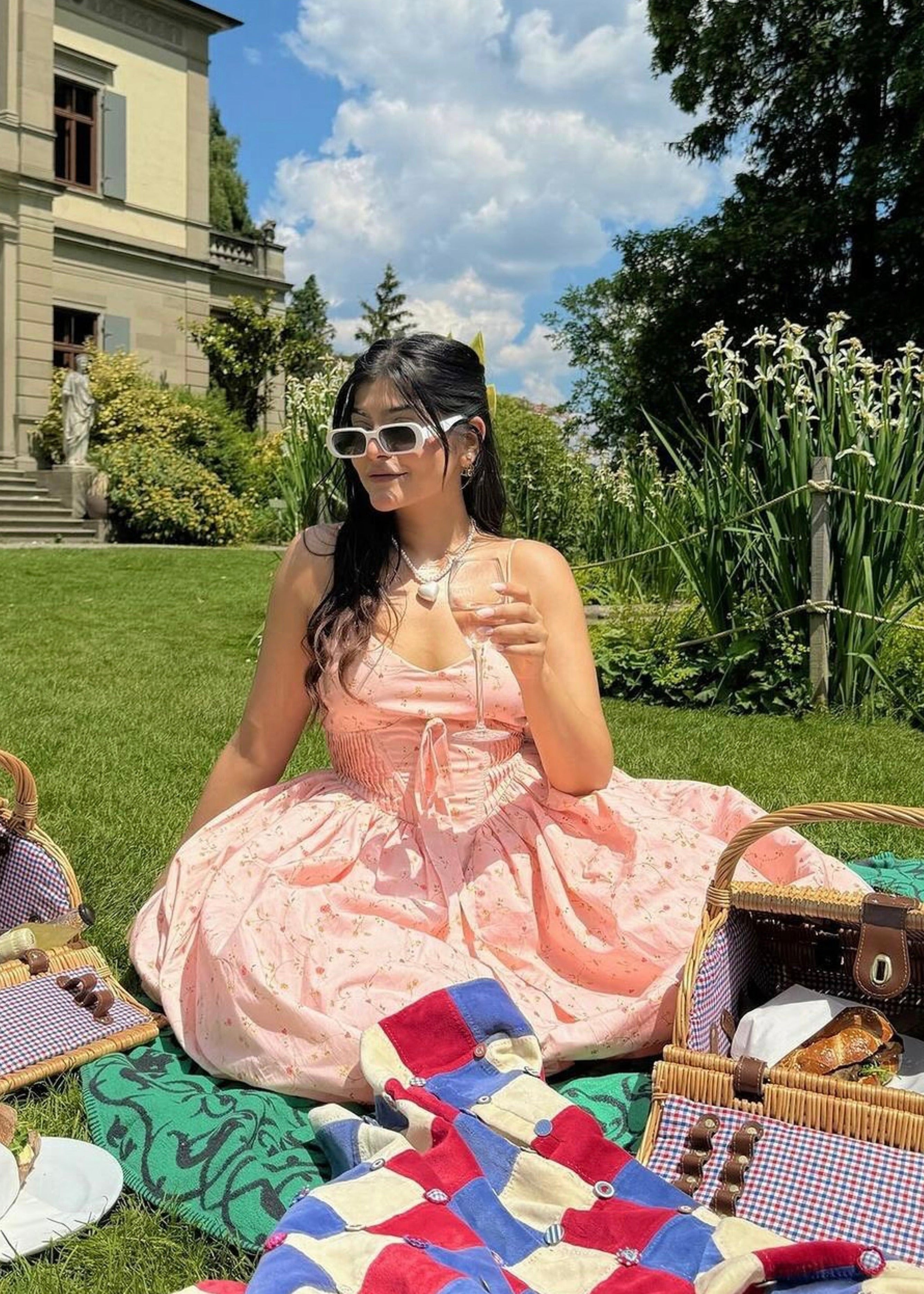 "Brynlee Baby Pink Floral Printed Corset Midi Dress: Charming baby pink midi dress with a floral print and a fitted corset top."