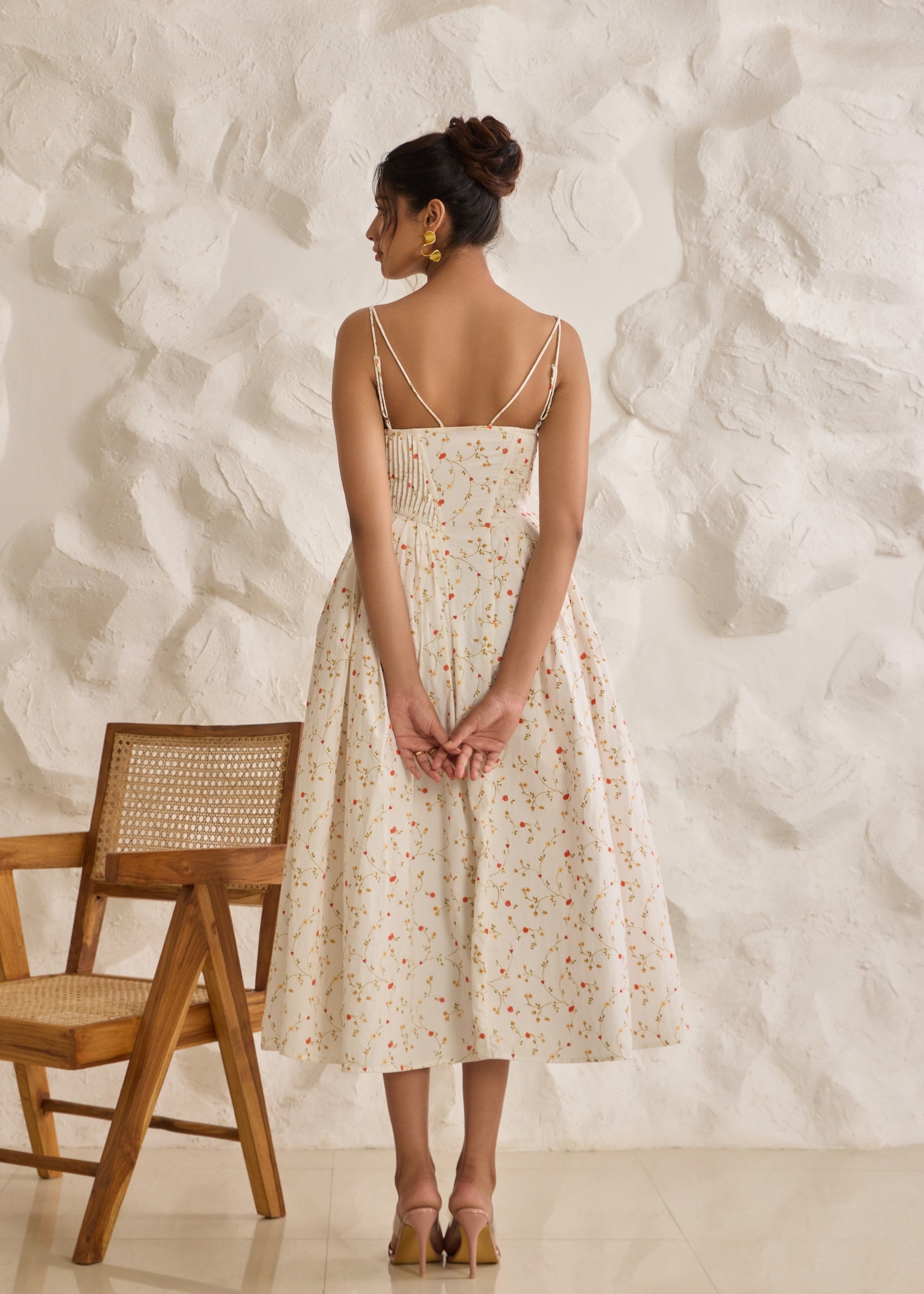 A graceful Brynlee white midi dress featuring a floral print and a corset bodice.