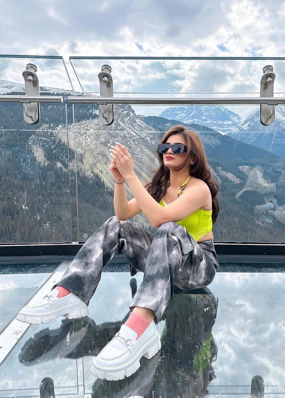 Stylish woman in a Danae Green Asymmetrical Corset Top, exuding modern flair