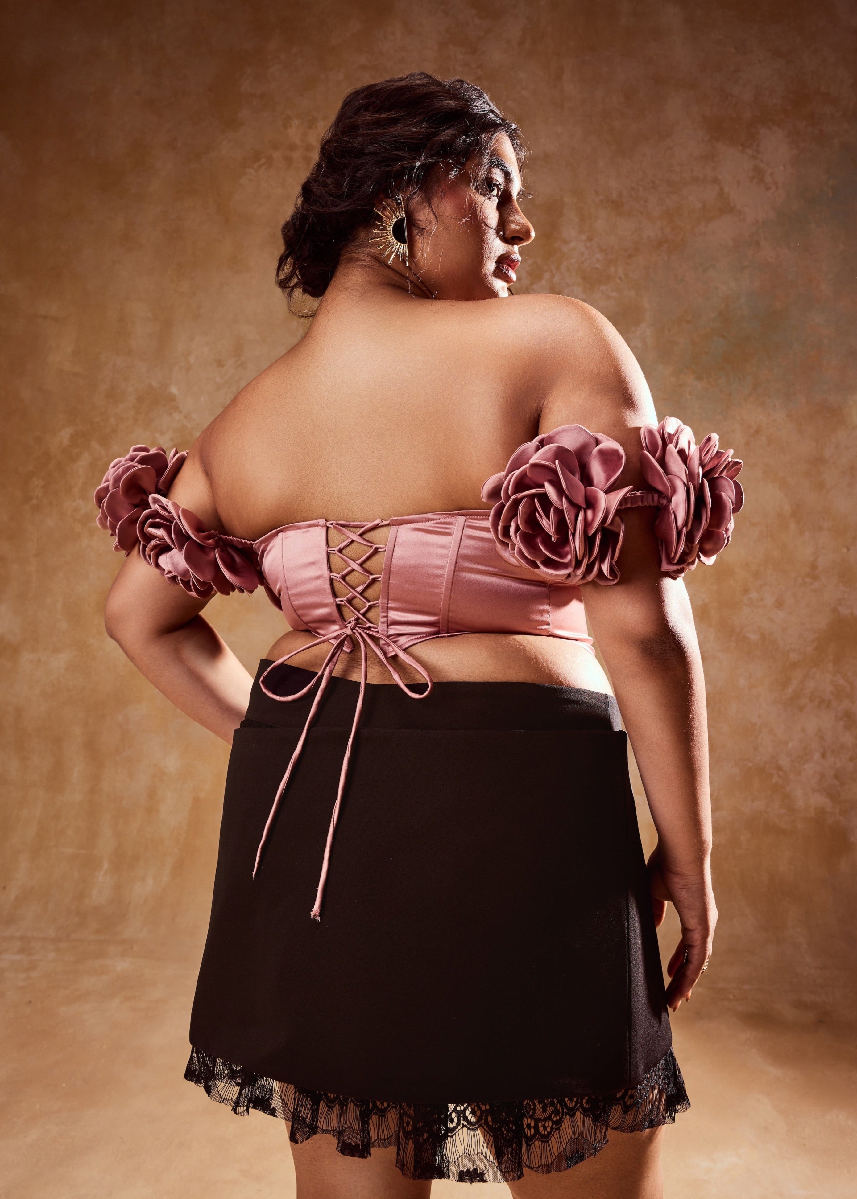 Embla Mauve Off-Shoulder Top and Black Mini Skirt, a stylish ensemble combining an off-shoulder top in mauve with a sleek black mini skirt.