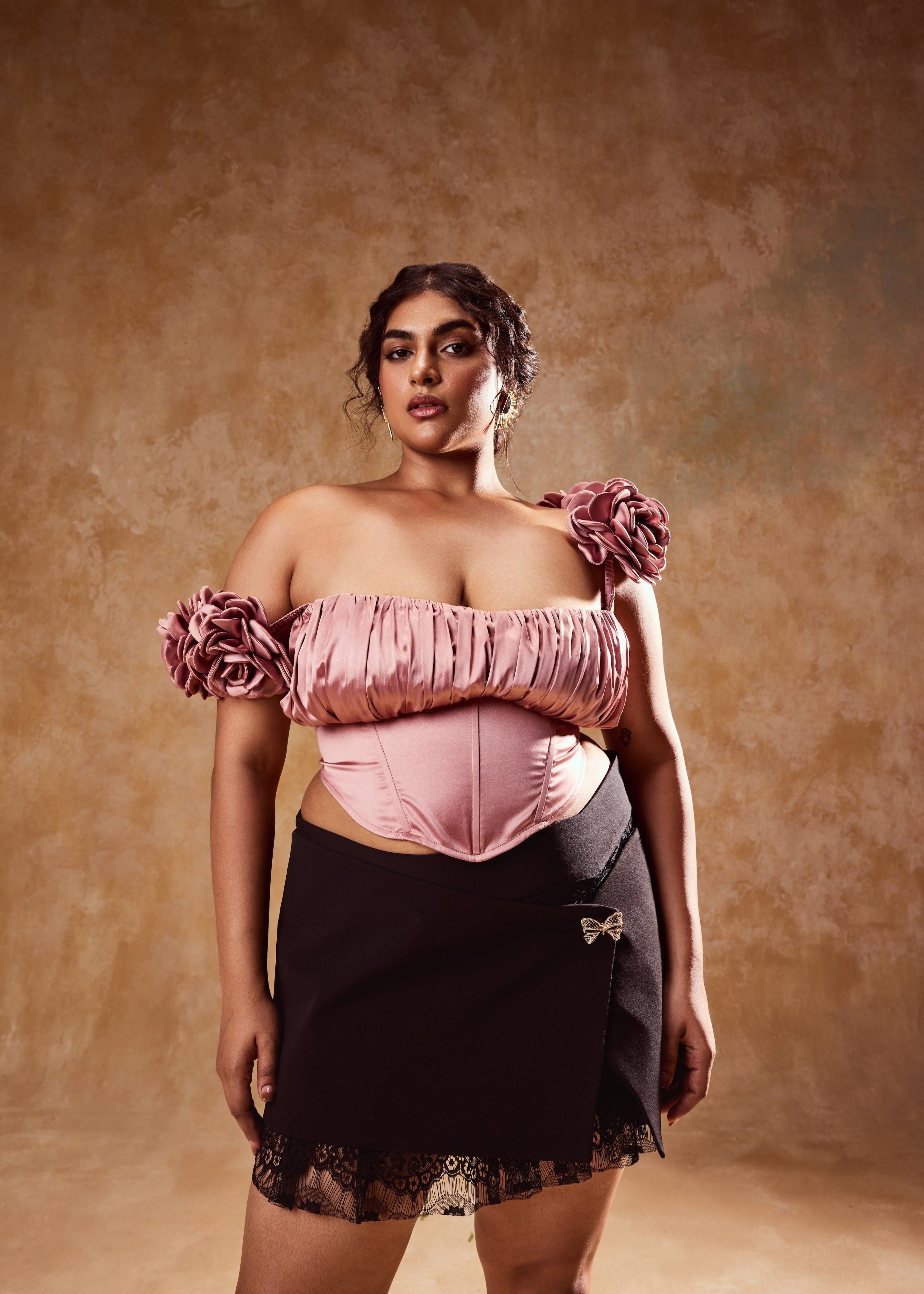 Embla Mauve Off-Shoulder Top and Black Mini Skirt, a stylish ensemble combining an off-shoulder top in mauve with a sleek black mini skirt.