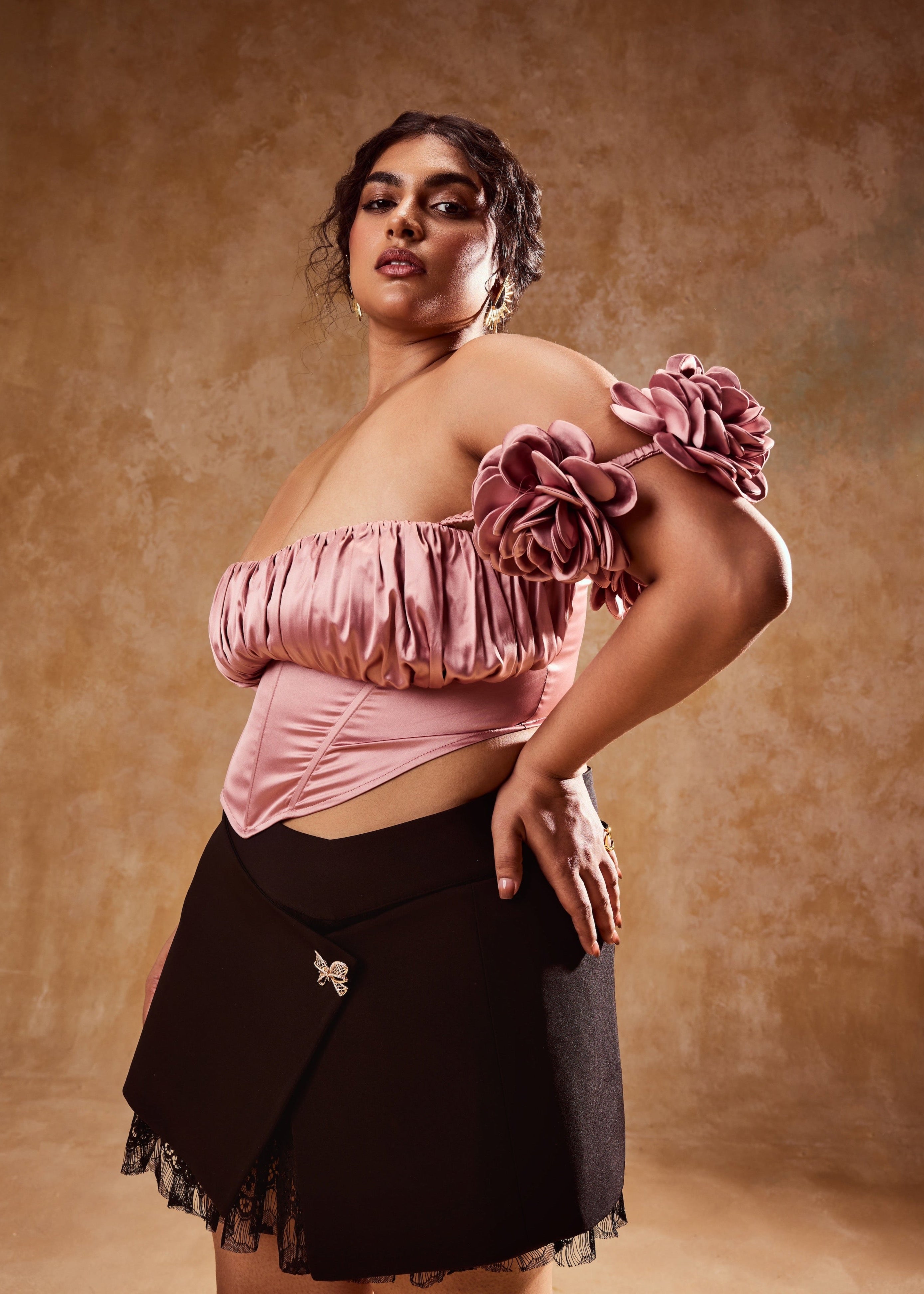 Embla Mauve Off-Shoulder Top and Black Mini Skirt, a stylish ensemble combining an off-shoulder top in mauve with a sleek black mini skirt.