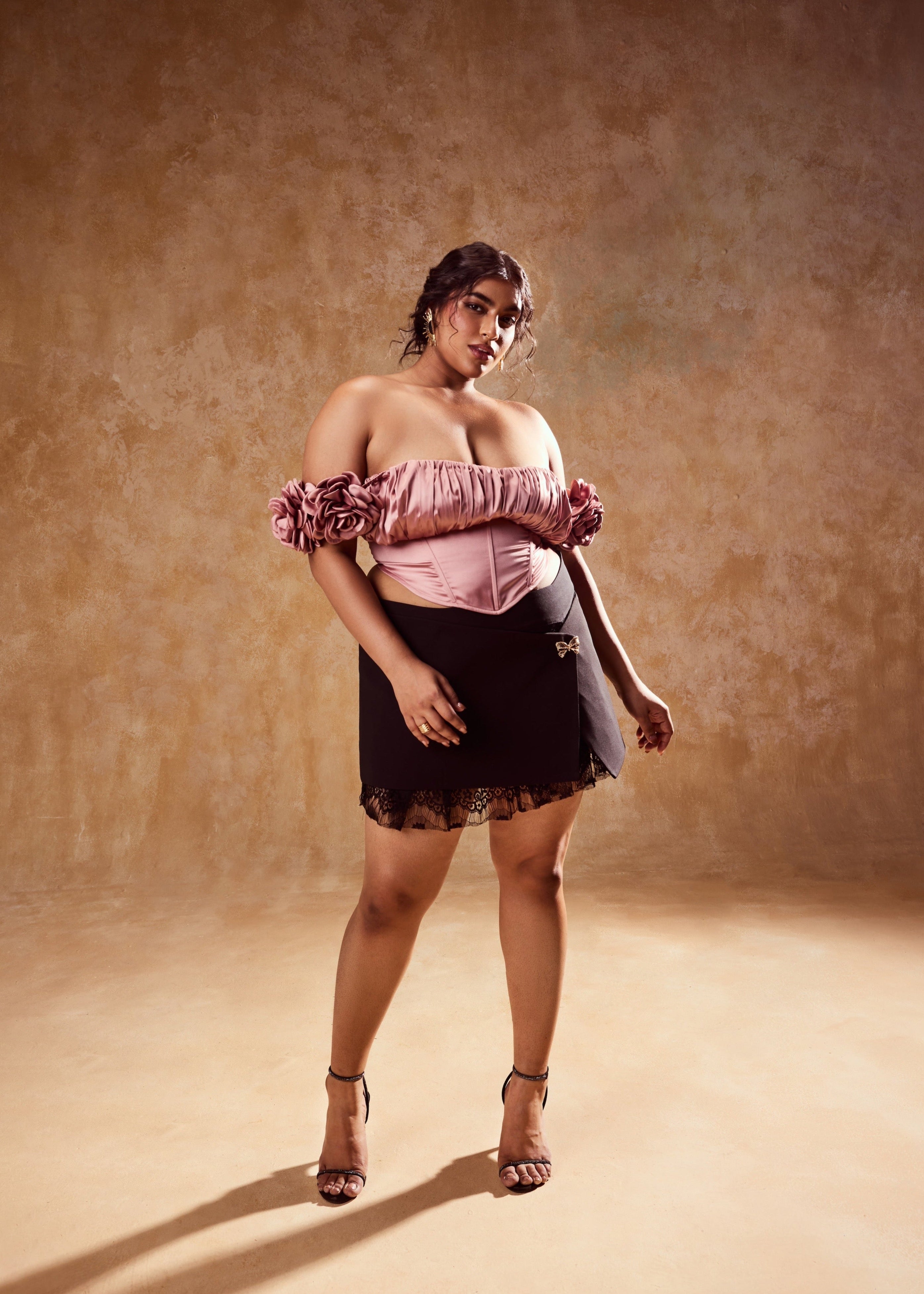 Embla Mauve Off-Shoulder Top and Black Mini Skirt, a stylish ensemble combining an off-shoulder top in mauve with a sleek black mini skirt.