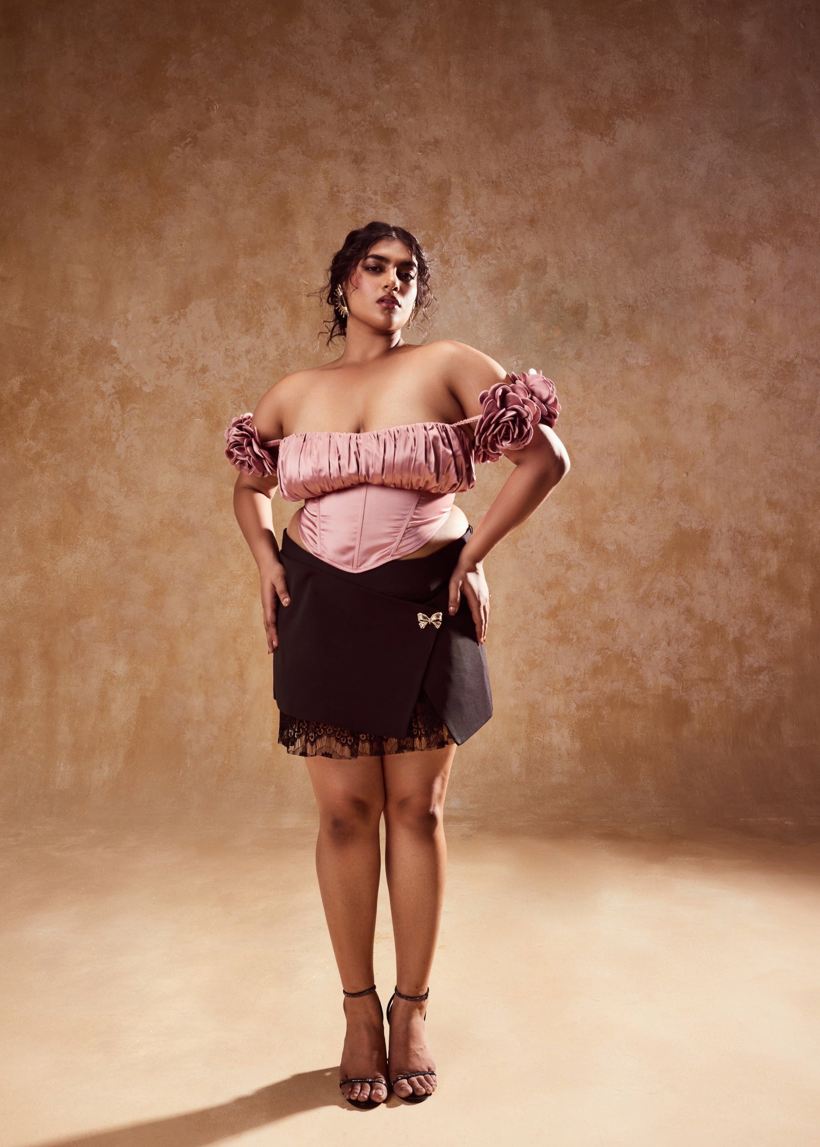 Embla Mauve Off-Shoulder Top and Black Mini Skirt, a stylish ensemble combining an off-shoulder top in mauve with a sleek black mini skirt.