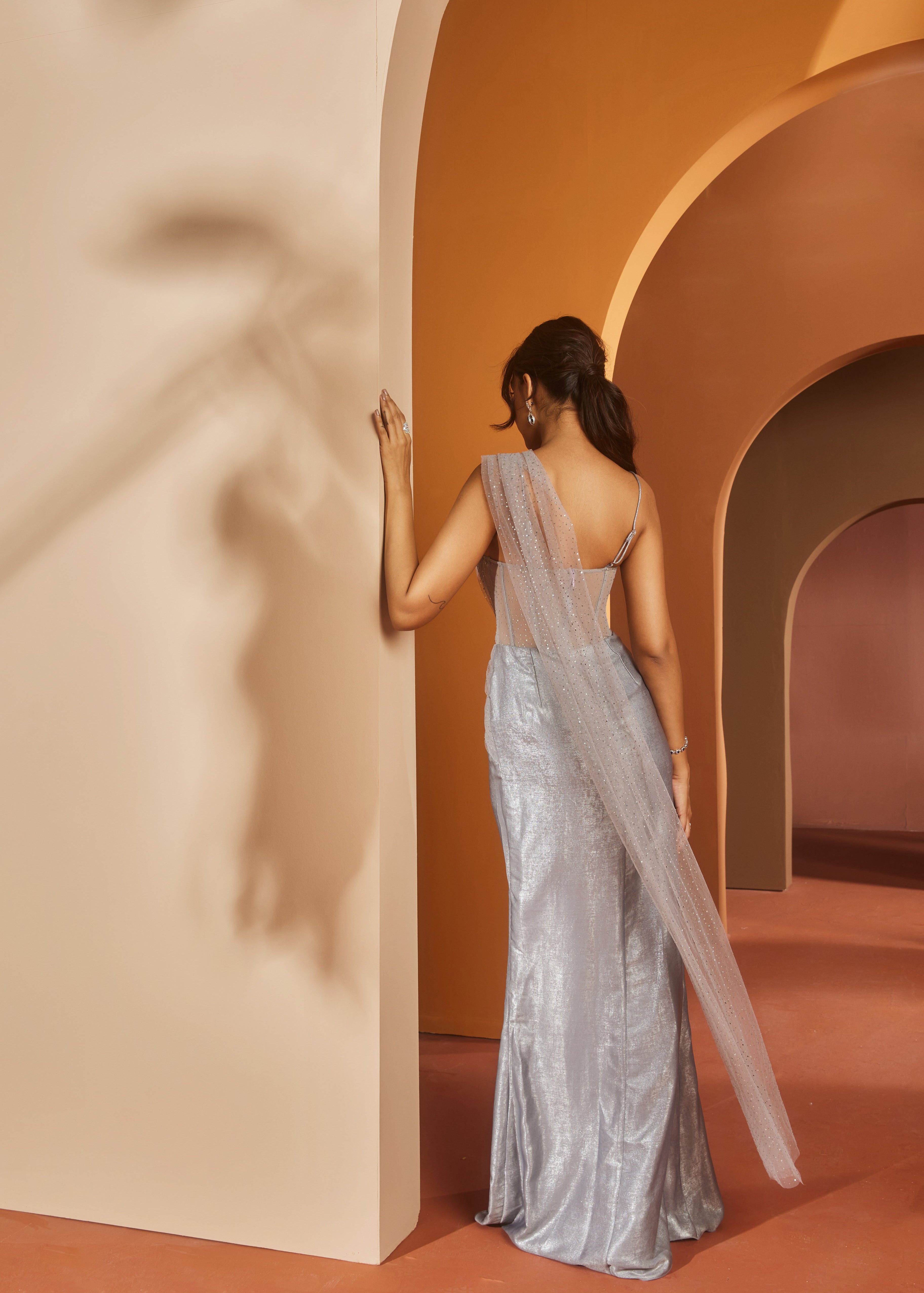 Elegant woman in a Faizah Grey Glitter Georgette One-Piece Saree Set, shimmering with sophistication