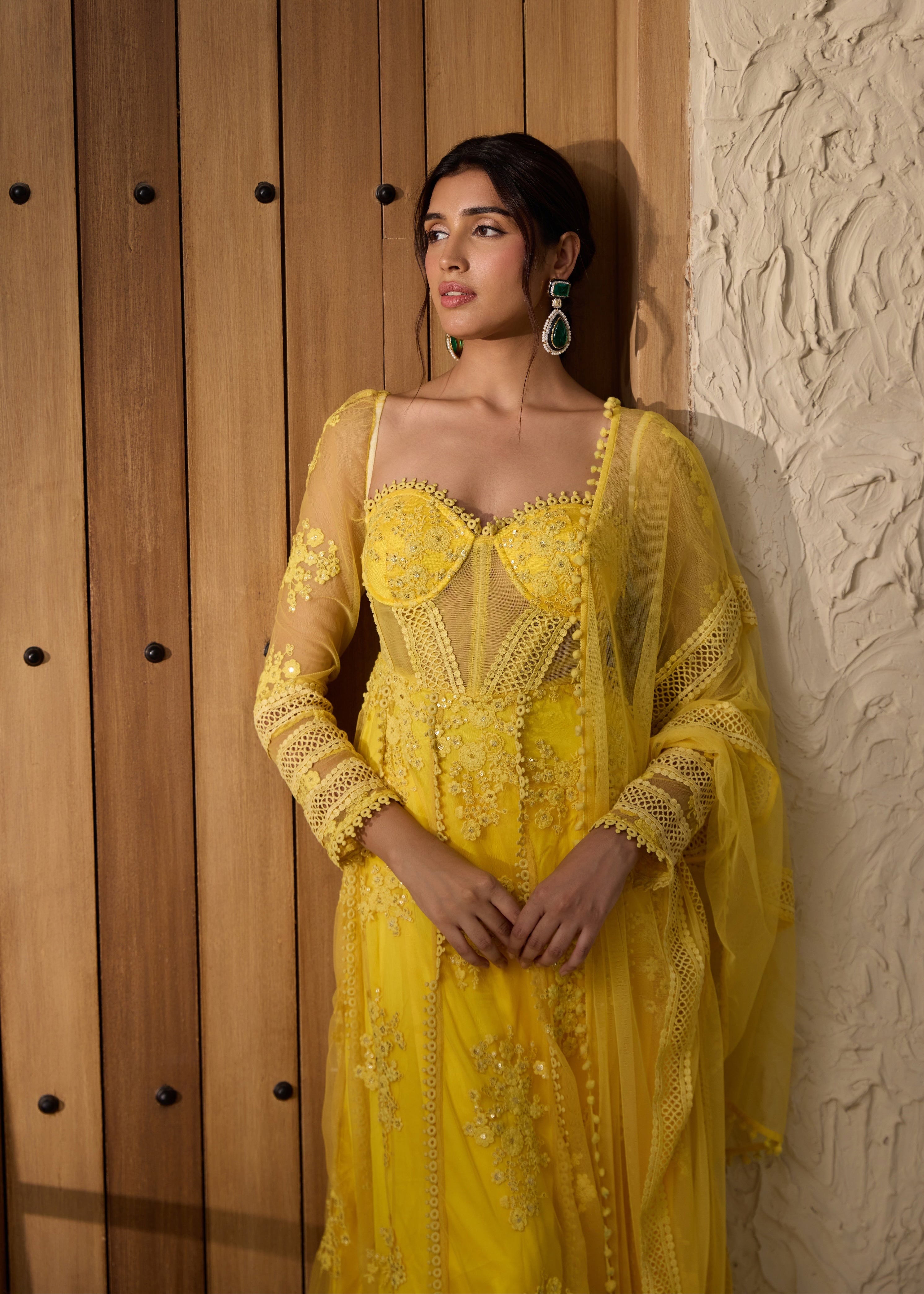 A yellow Anarkali suit set with an embroidered corset top.