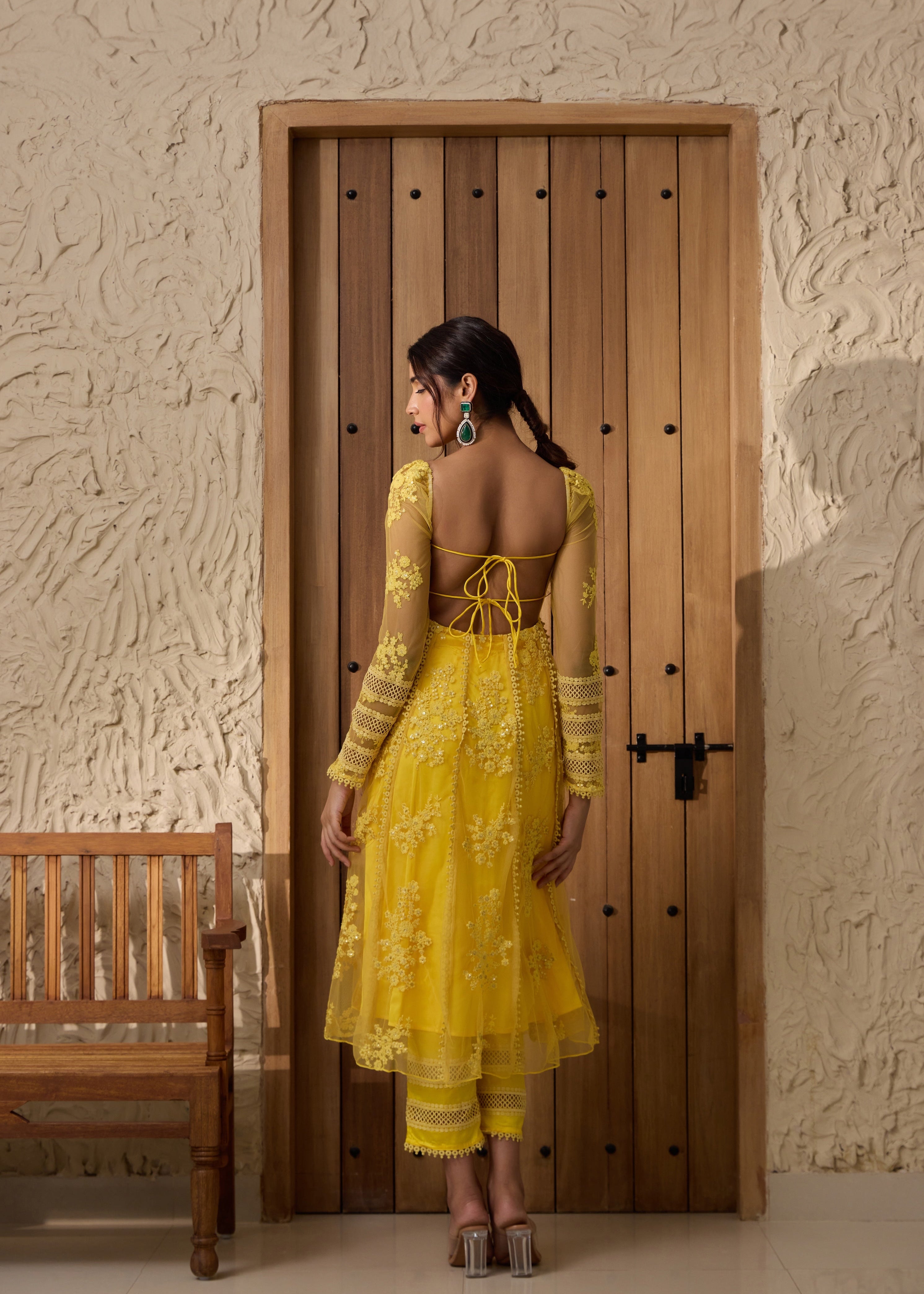 A yellow Anarkali suit set with an embroidered corset top.