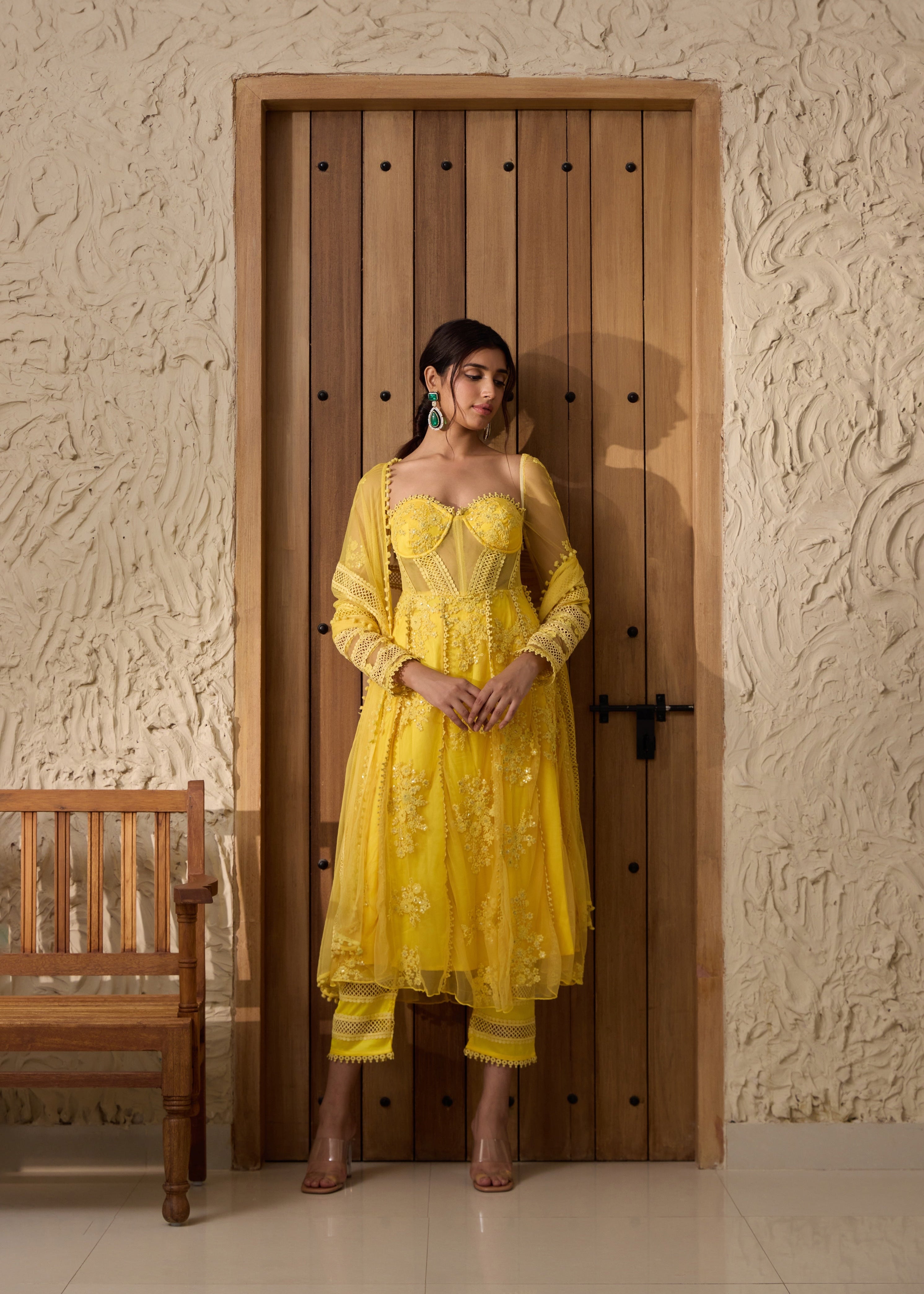 A yellow Anarkali suit set with an embroidered corset top.