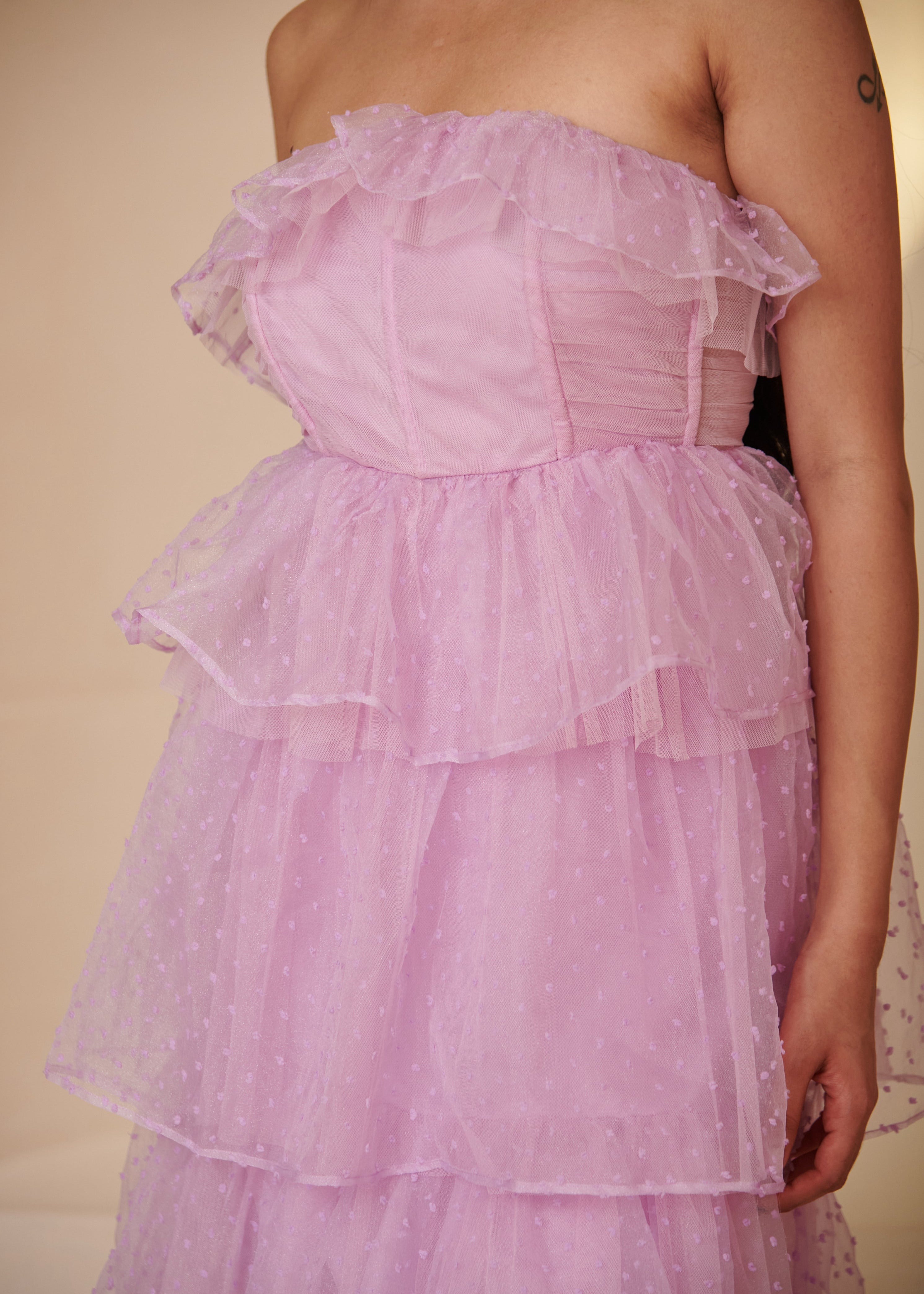 Stylish woman in a Florine Purple Organza Bandeau Corset Dress, showcasing ethereal elegance