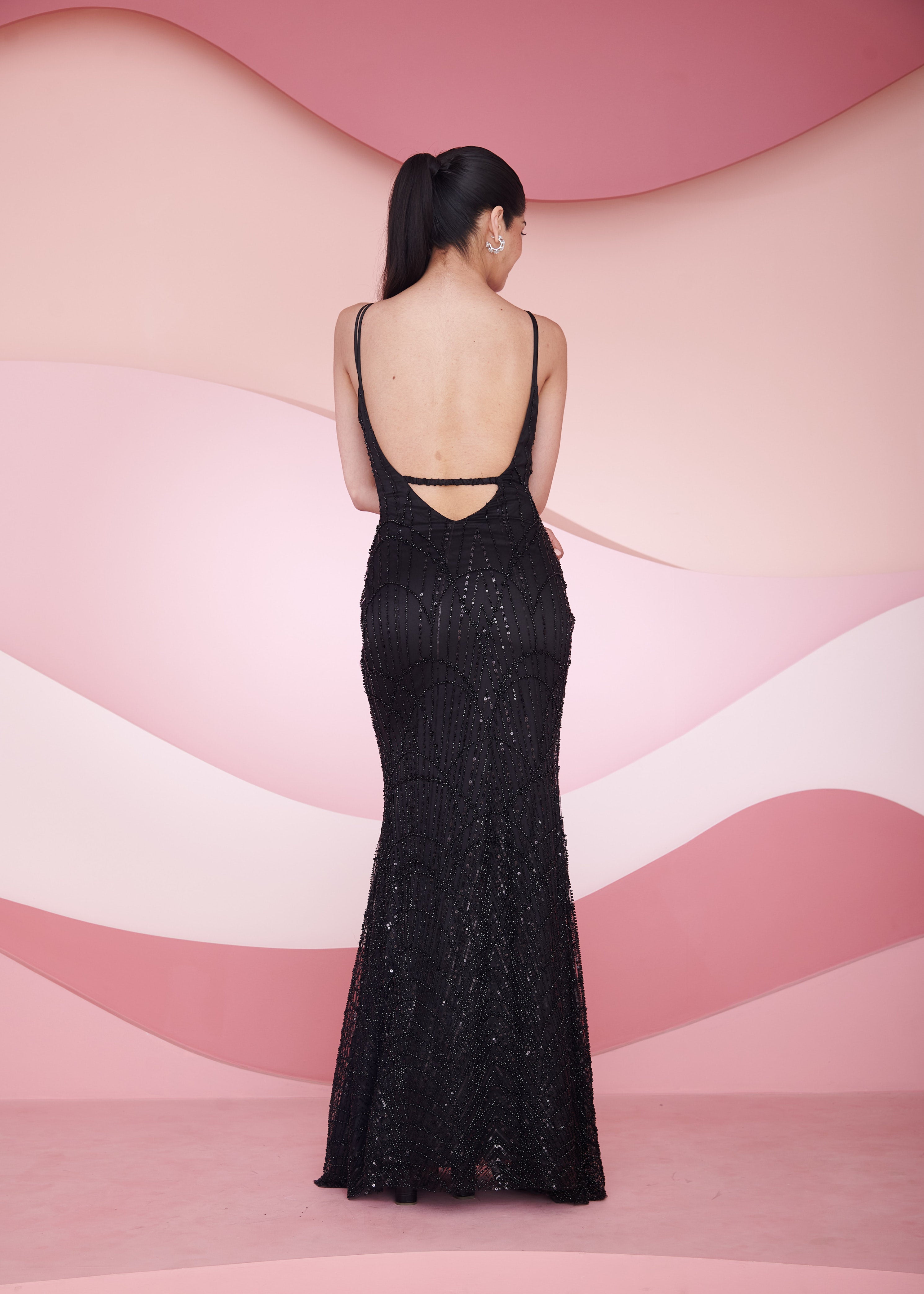Stunning woman in a Georgia Black Hand Embroidered Backless Gown displaying elegance and sophistication