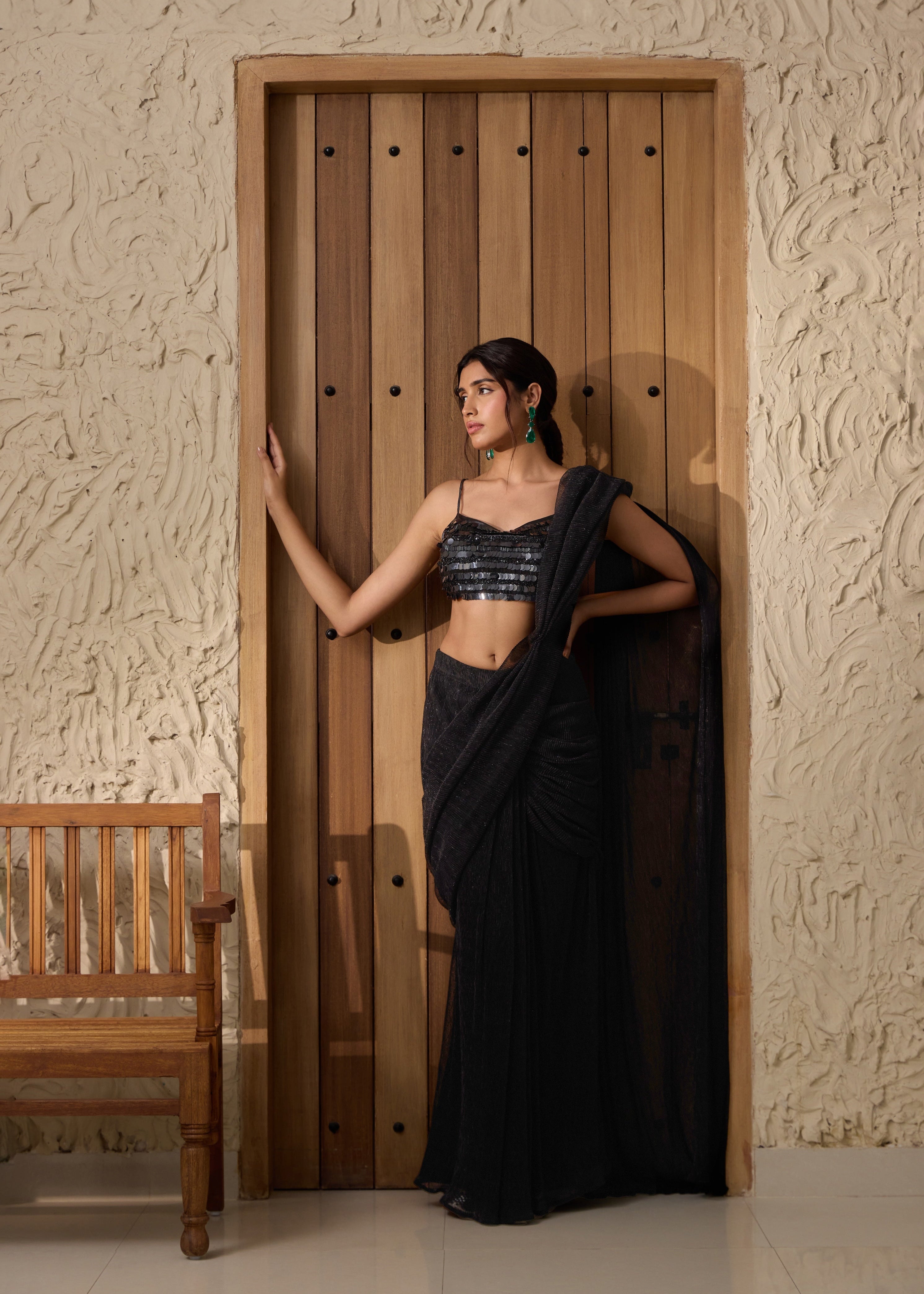 A black shimmer pre-draped saree set.
