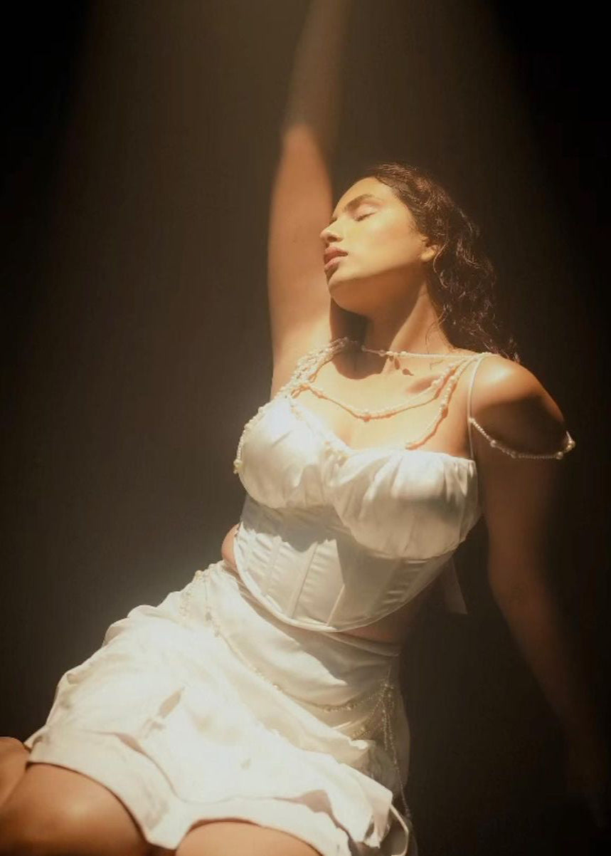 Elegant woman in a Linea White Satin and Pearl Embroidered Corset Set, exuding timeless sophistication