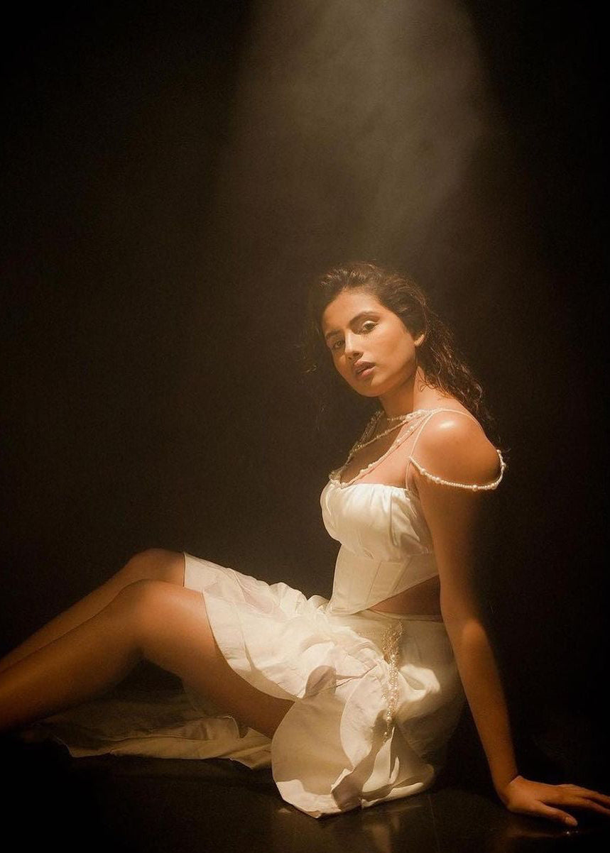 Elegant woman in a Linea White Satin and Pearl Embroidered Corset Set, exuding timeless sophistication