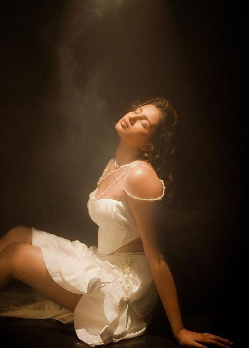 Elegant woman in a Linea White Satin and Pearl Embroidered Corset Set, exuding timeless sophistication