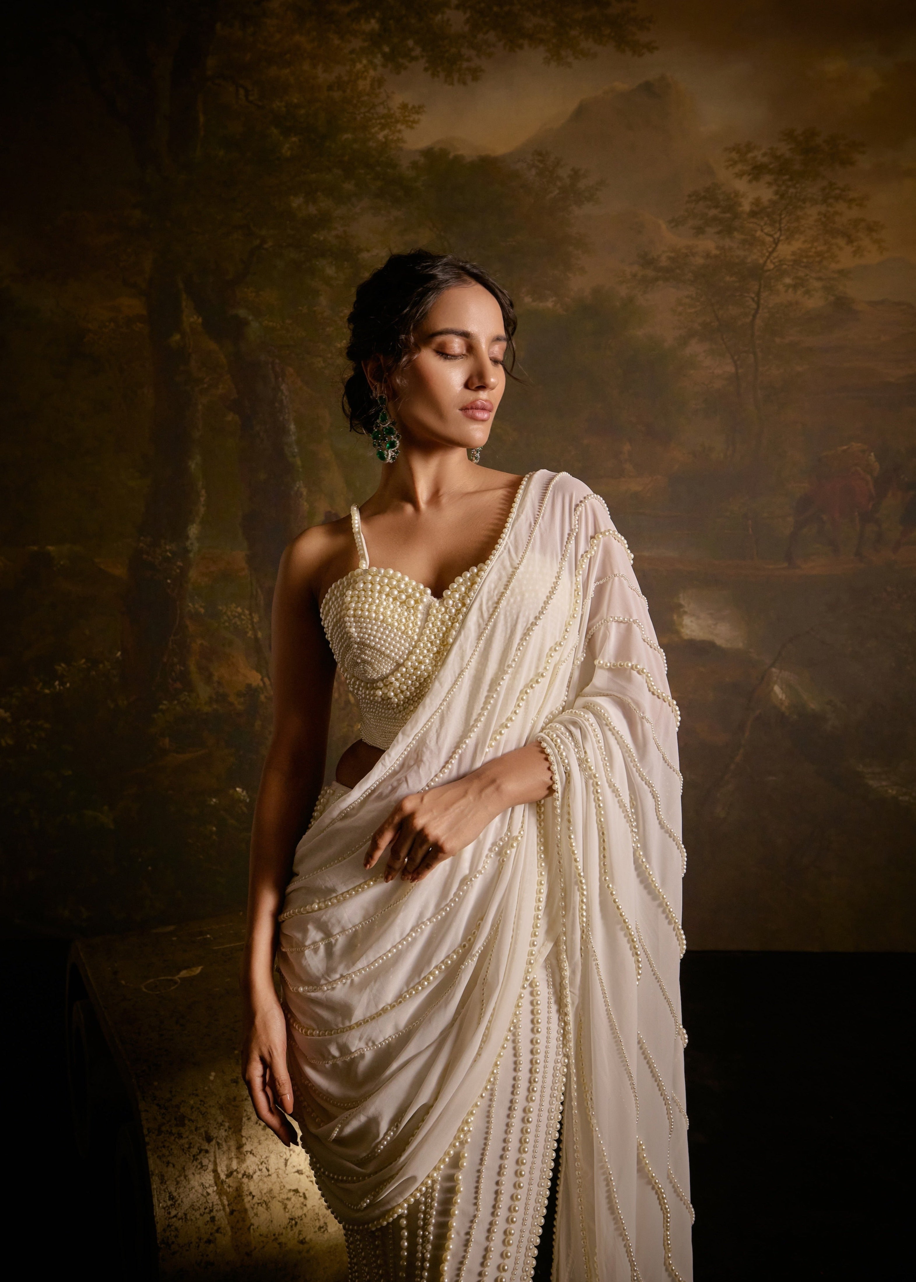 "Mahima White Pearl Embroidered Saree: White saree adorned with delicate pearl embroidery for an elegant and sophisticated look."