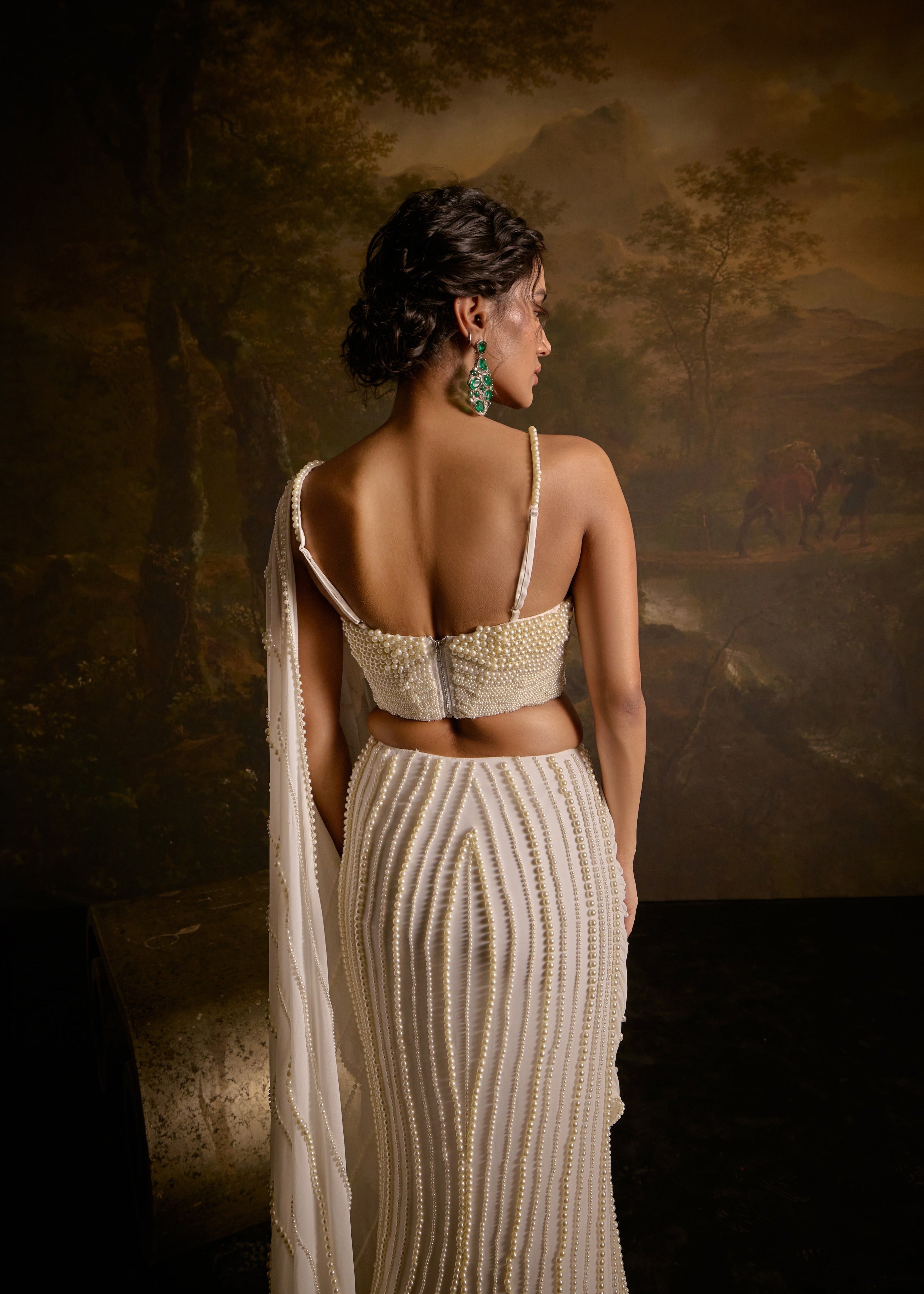 "Mahima White Pearl Embroidered Saree: White saree adorned with delicate pearl embroidery for an elegant and sophisticated look."
