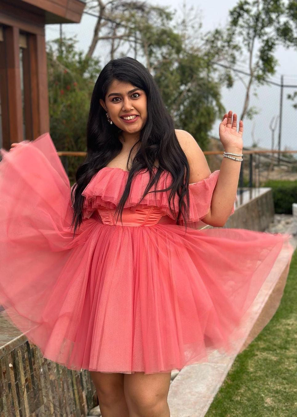 Graceful woman in a Maxine Pink Ruffle Tulle Corset Dress, showcasing romantic elegance