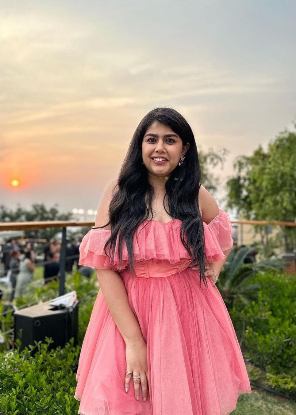 Graceful woman in a Maxine Pink Ruffle Tulle Corset Dress, showcasing romantic elegance