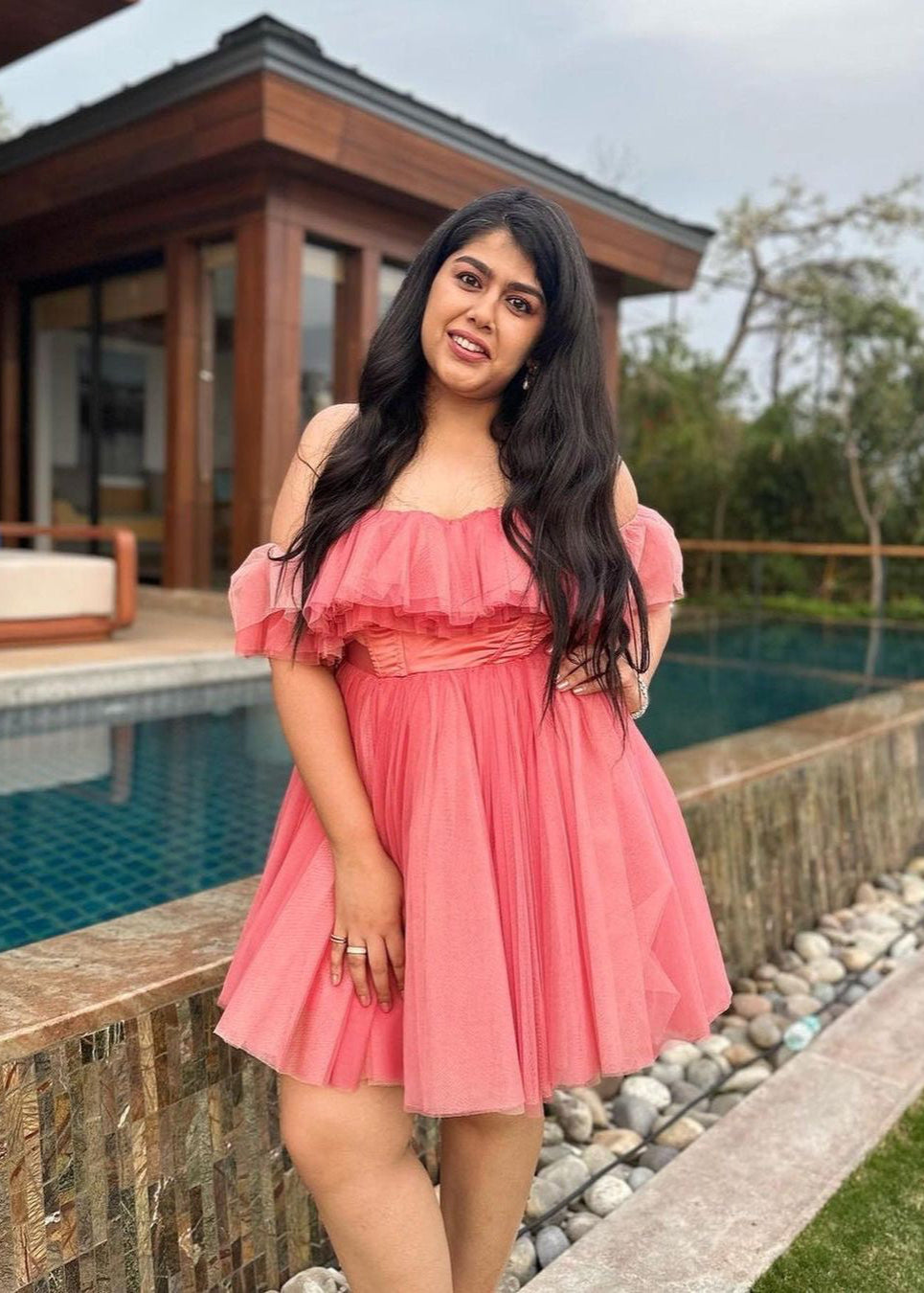 Graceful woman in a Maxine Pink Ruffle Tulle Corset Dress, showcasing romantic elegance