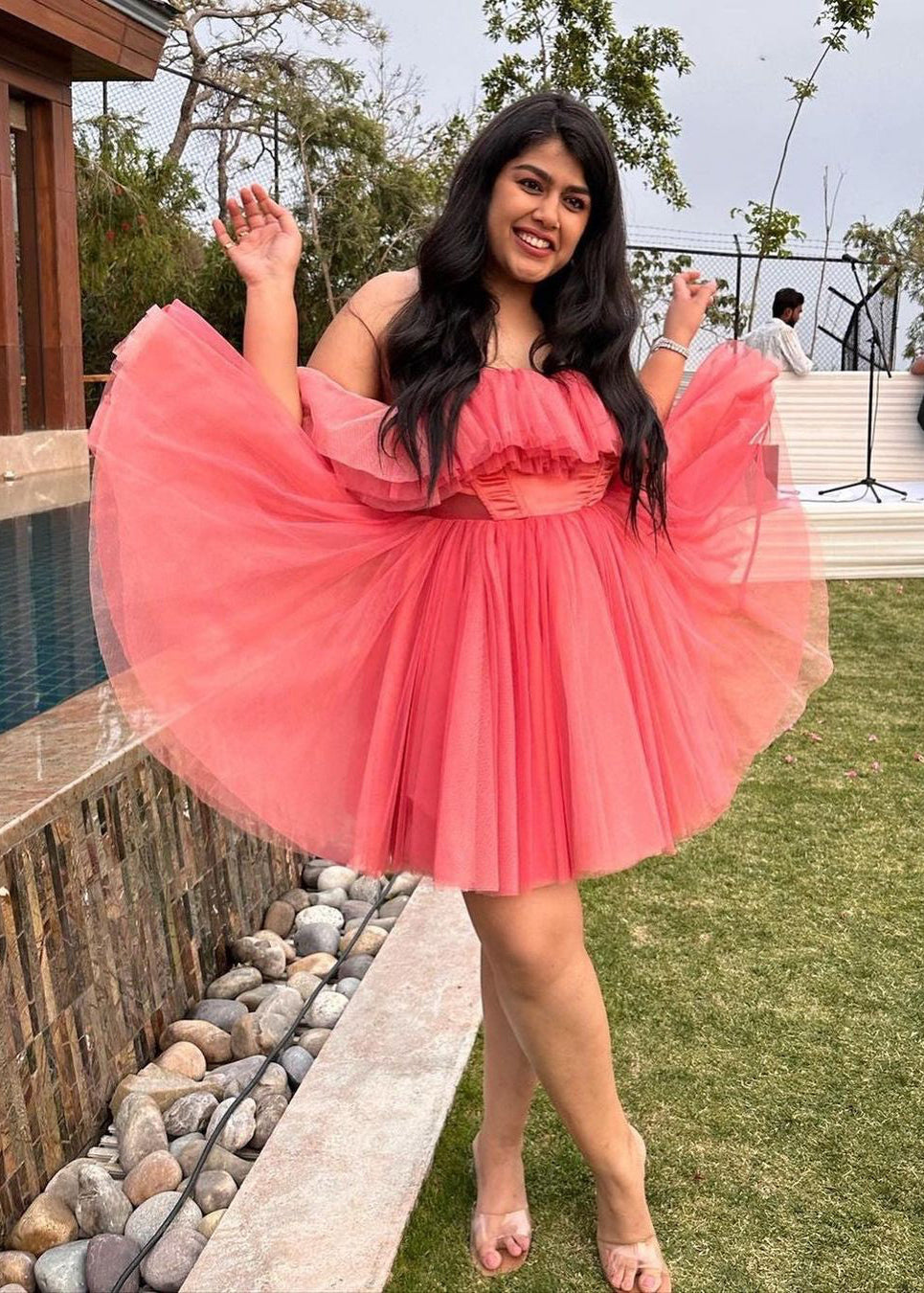 Graceful woman in a Maxine Pink Ruffle Tulle Corset Dress, showcasing romantic elegance