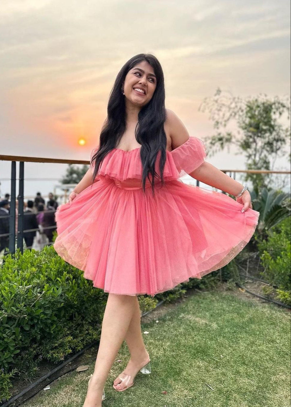 Graceful woman in a Maxine Pink Ruffle Tulle Corset Dress, showcasing romantic elegance