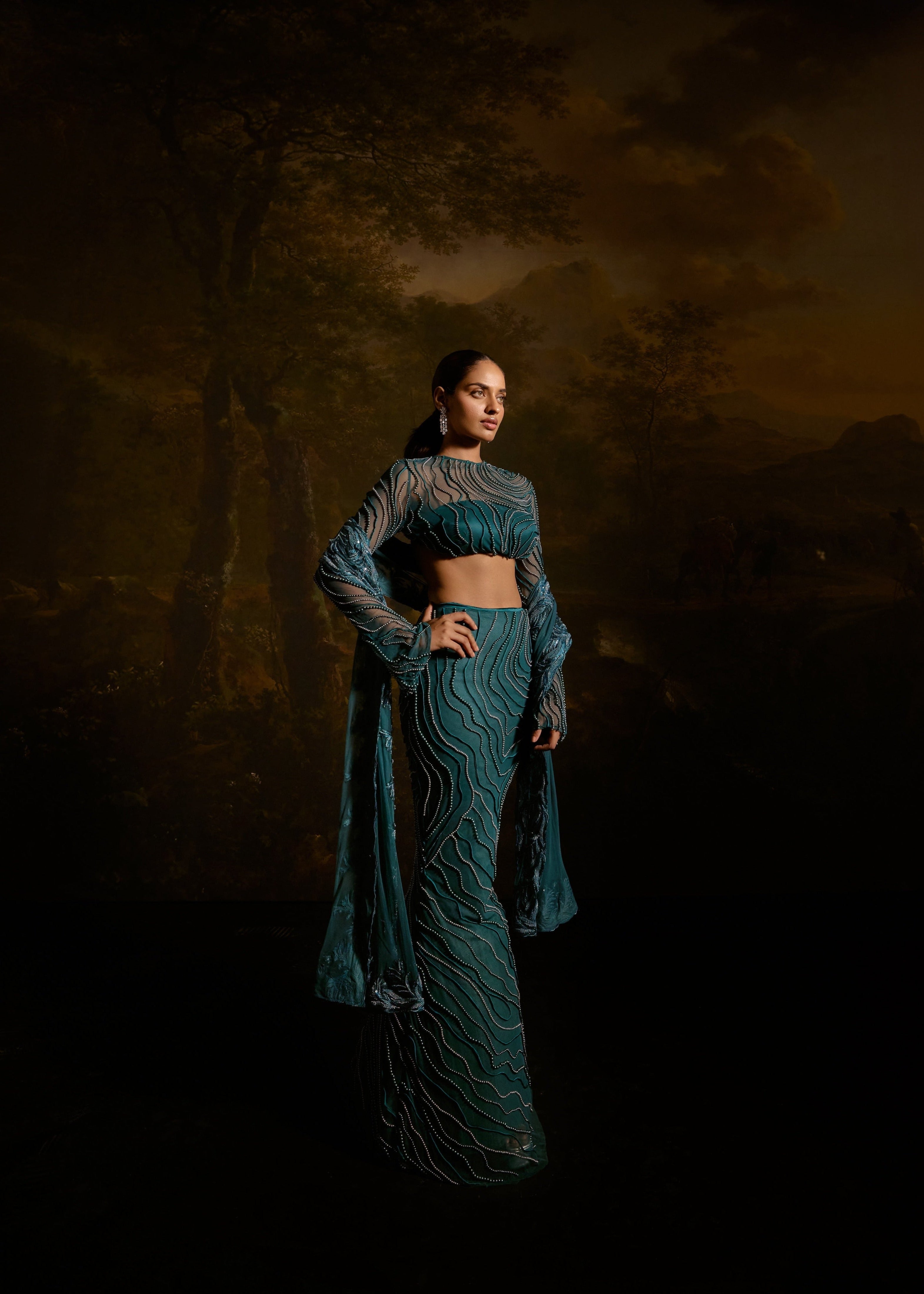 "Meera Teal Embroidered Lehenga Set: Teal lehenga set with intricate embroidery for a graceful and traditional appearance."