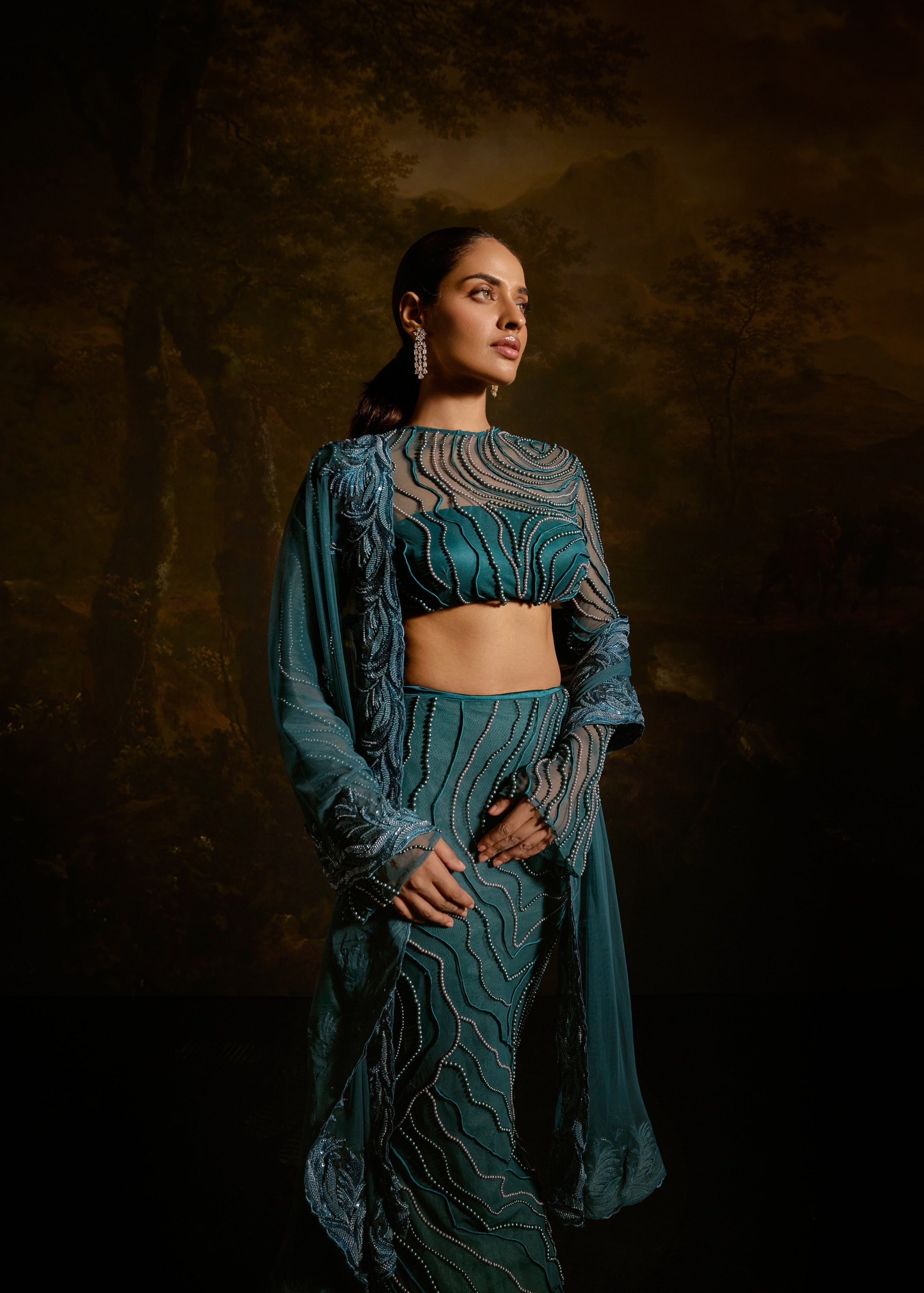 "Meera Teal Embroidered Lehenga Set: Teal lehenga set with intricate embroidery for a graceful and traditional appearance."