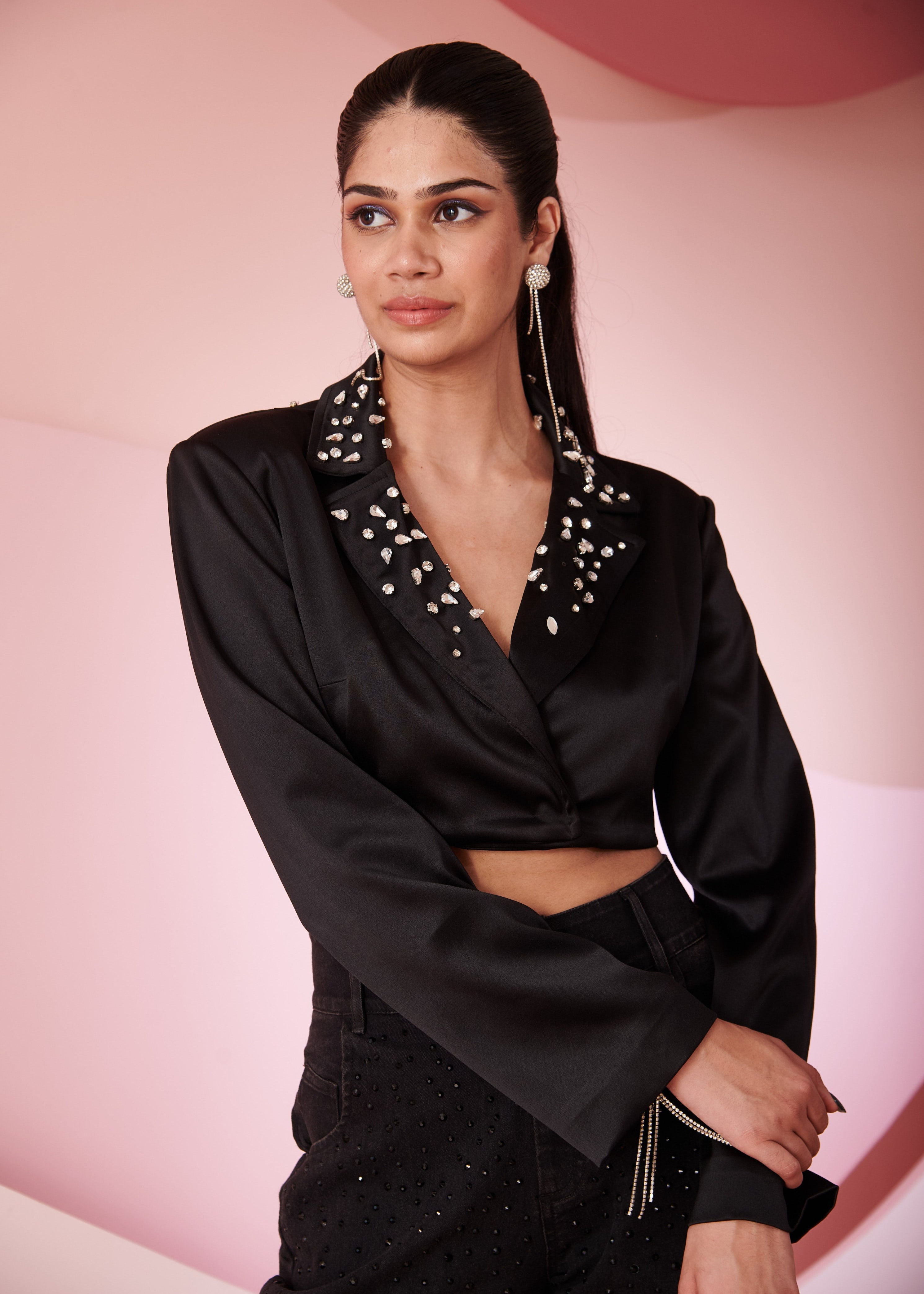 Fashion-forward woman in a Mila Black Satin Crop Jacket, showcasing sleek and modern style