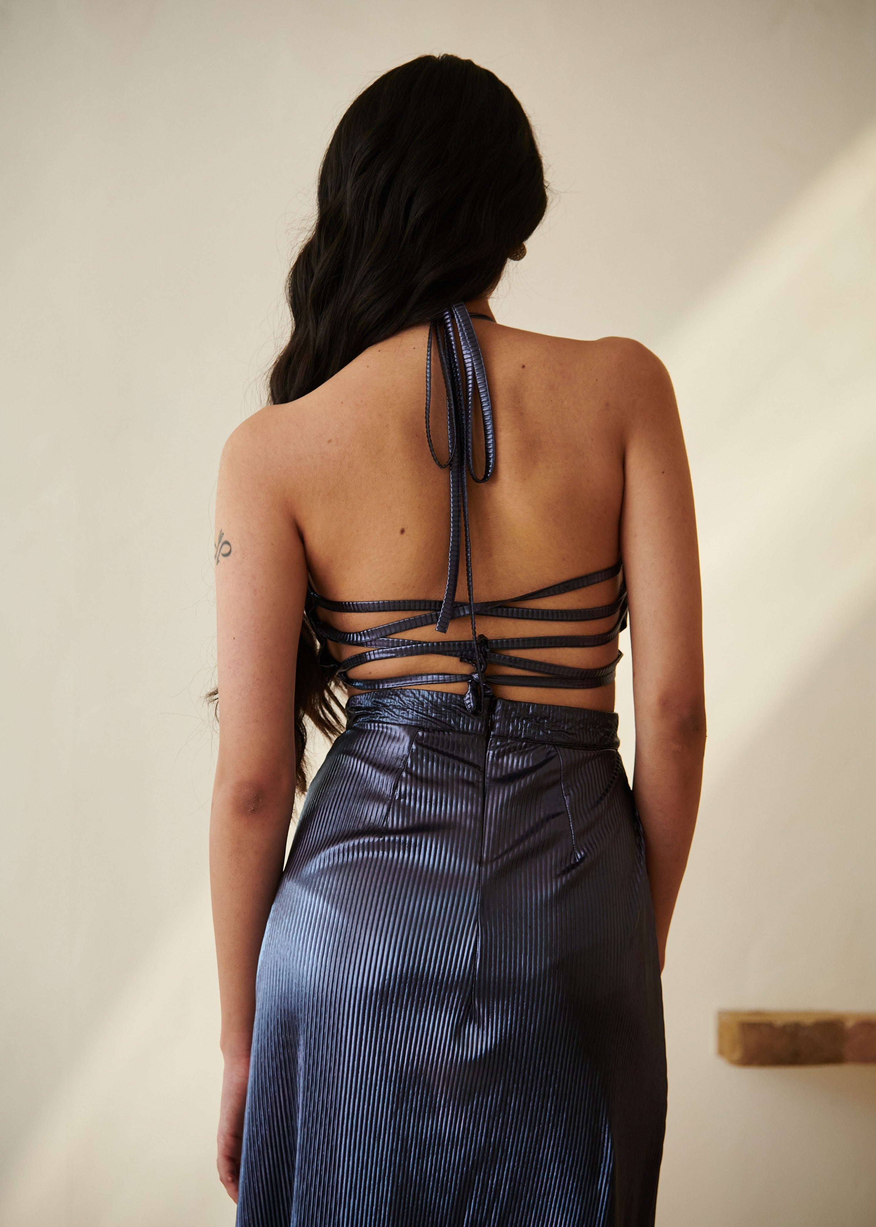 Elegant woman in a Moana Navy Blue Metallic Maxi Dress posing gracefully