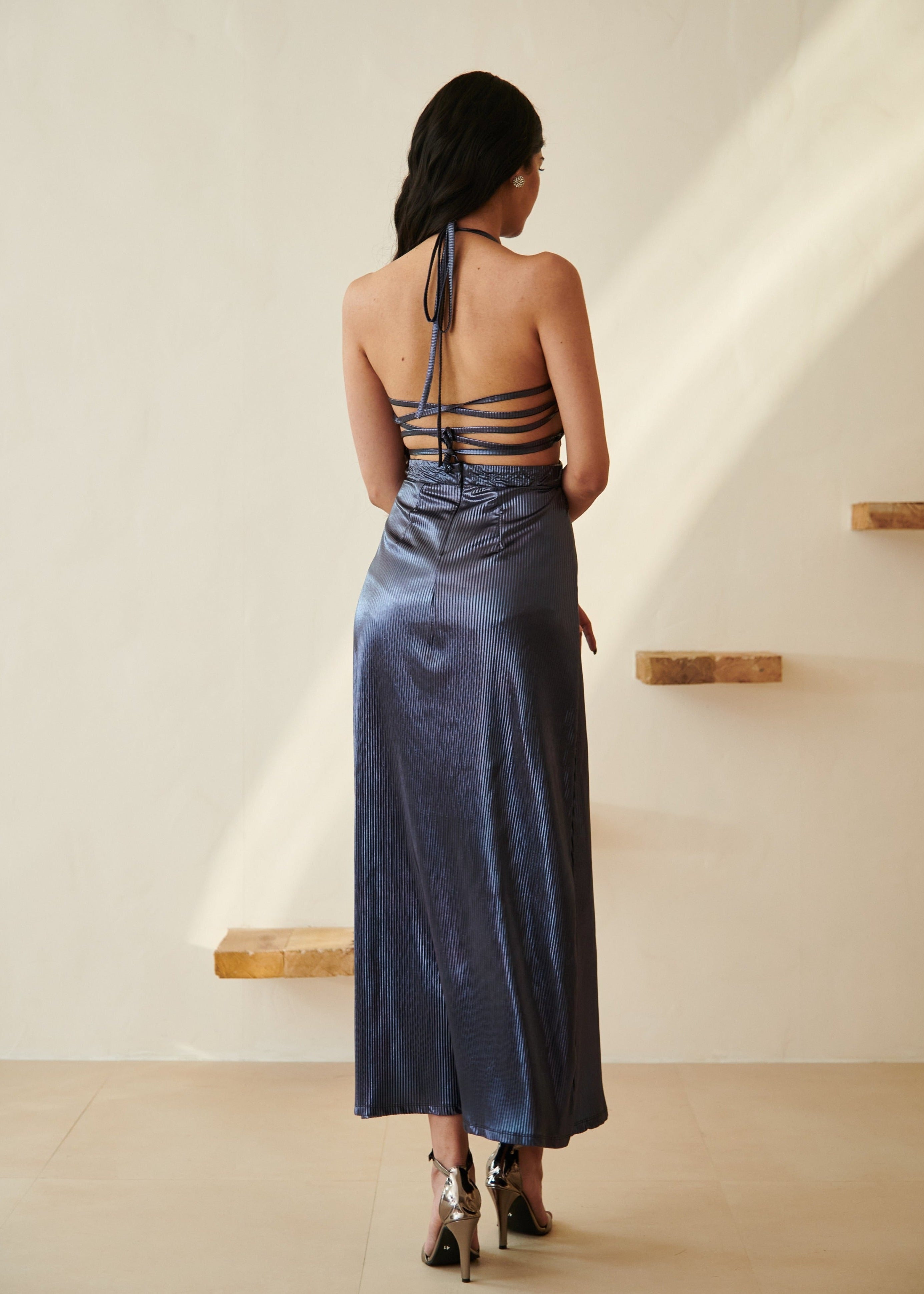 Elegant woman in a Moana Navy Blue Metallic Maxi Dress posing gracefully