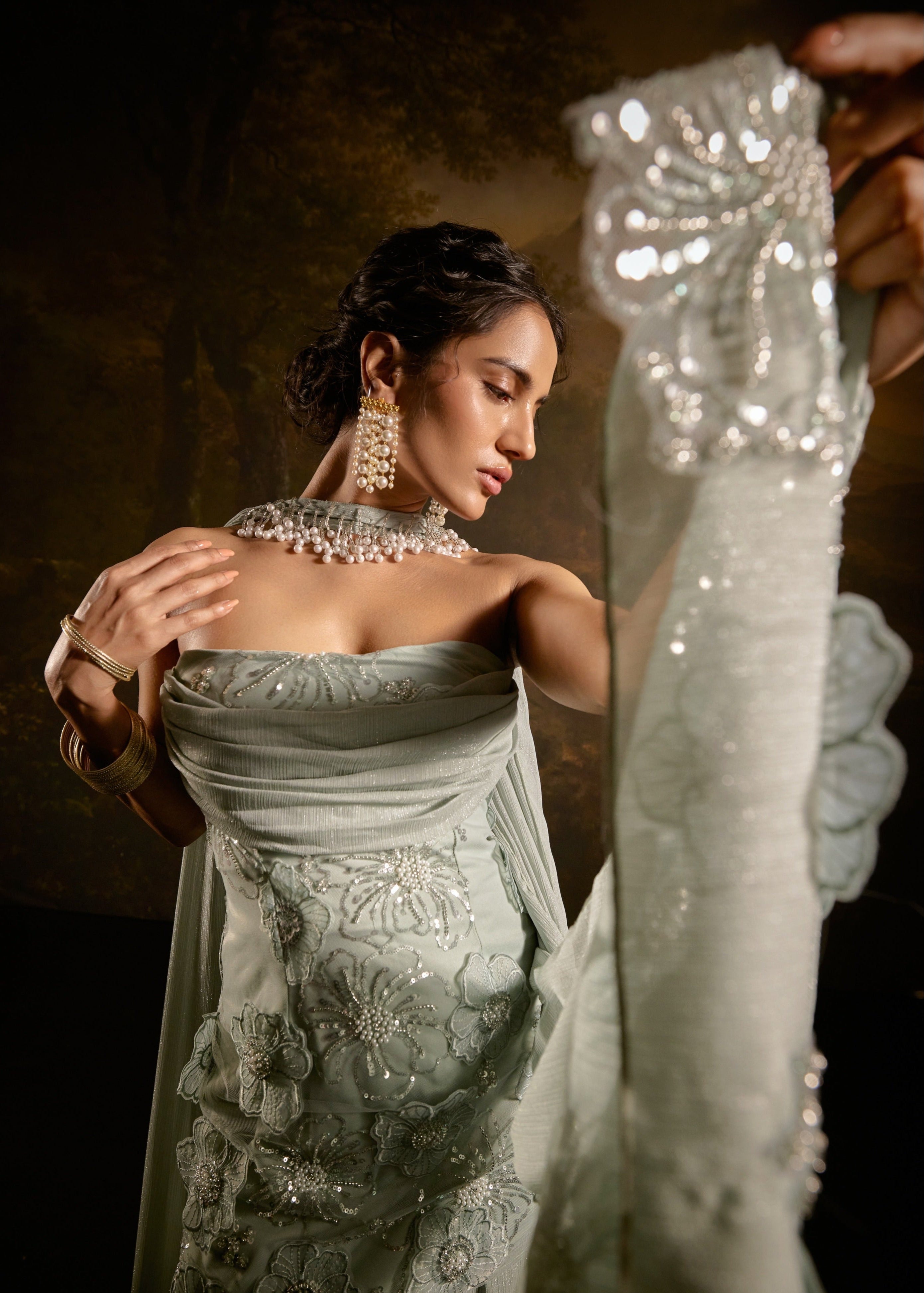 "Nakhat Sage Green 3D Flower Embroidered Sleeveless Sharara Set: Stylish sleeveless sharara set in sage green, adorned with intricate 3D flower embroidery for a unique and elegant look."