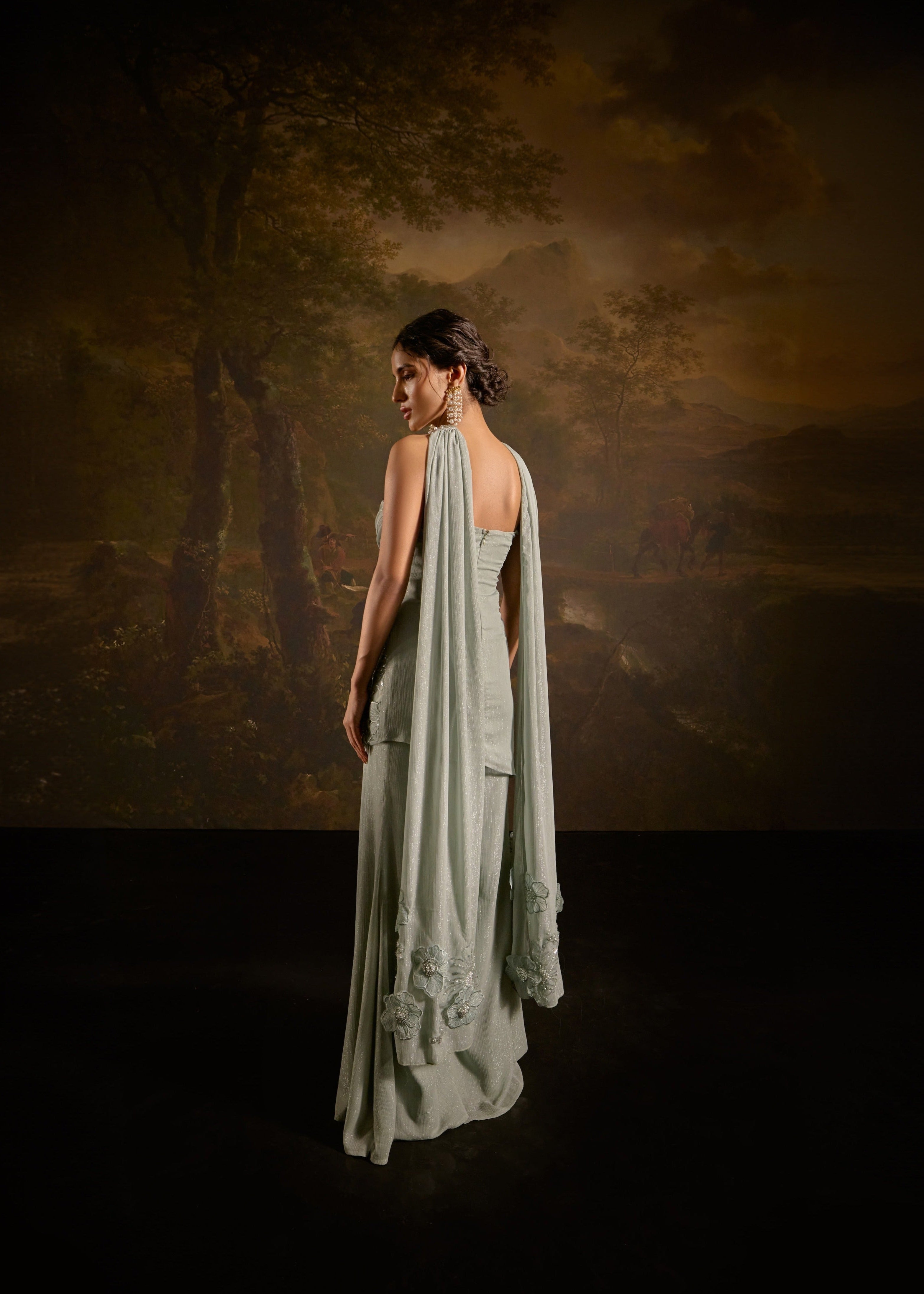 "Nakhat Sage Green 3D Flower Embroidered Sleeveless Sharara Set: Stylish sleeveless sharara set in sage green, adorned with intricate 3D flower embroidery for a unique and elegant look."