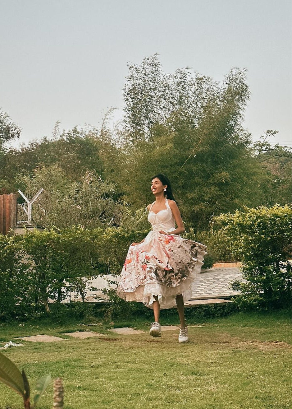 Oaklynn White Floral Corset Halter Midi Dress featuring a fitted bodice and flowy skirt adorned with delicate floral patterns