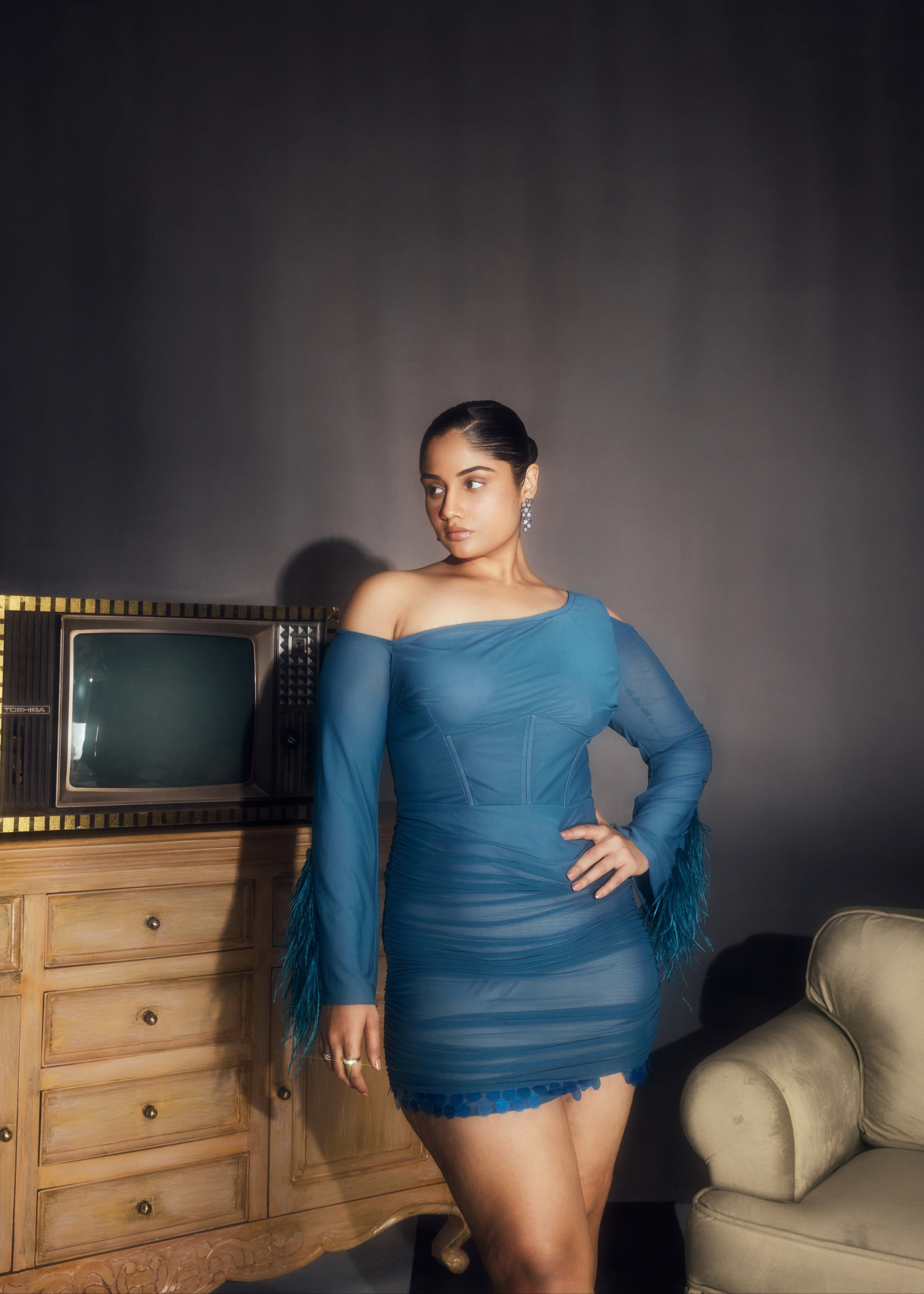 Peyton Teal Ruched Power Mesh Feather Embellished Corset Mini Dress, showcasing dramatic feathers and a flattering corset fit