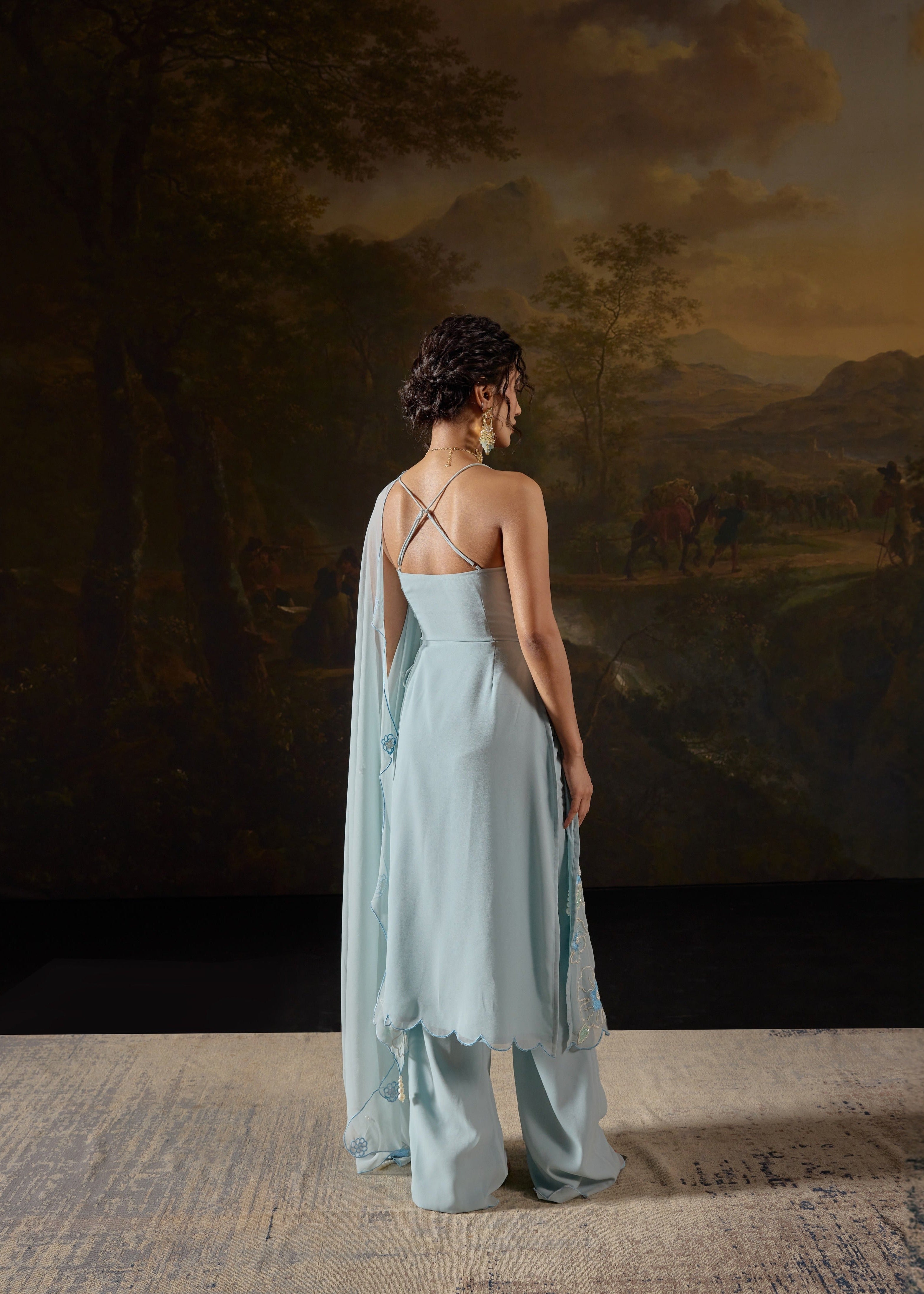 Raaya Baby Blue Hand-Embroidered Sleeveless Suit featuring intricate floral designs and lightweight fabric."