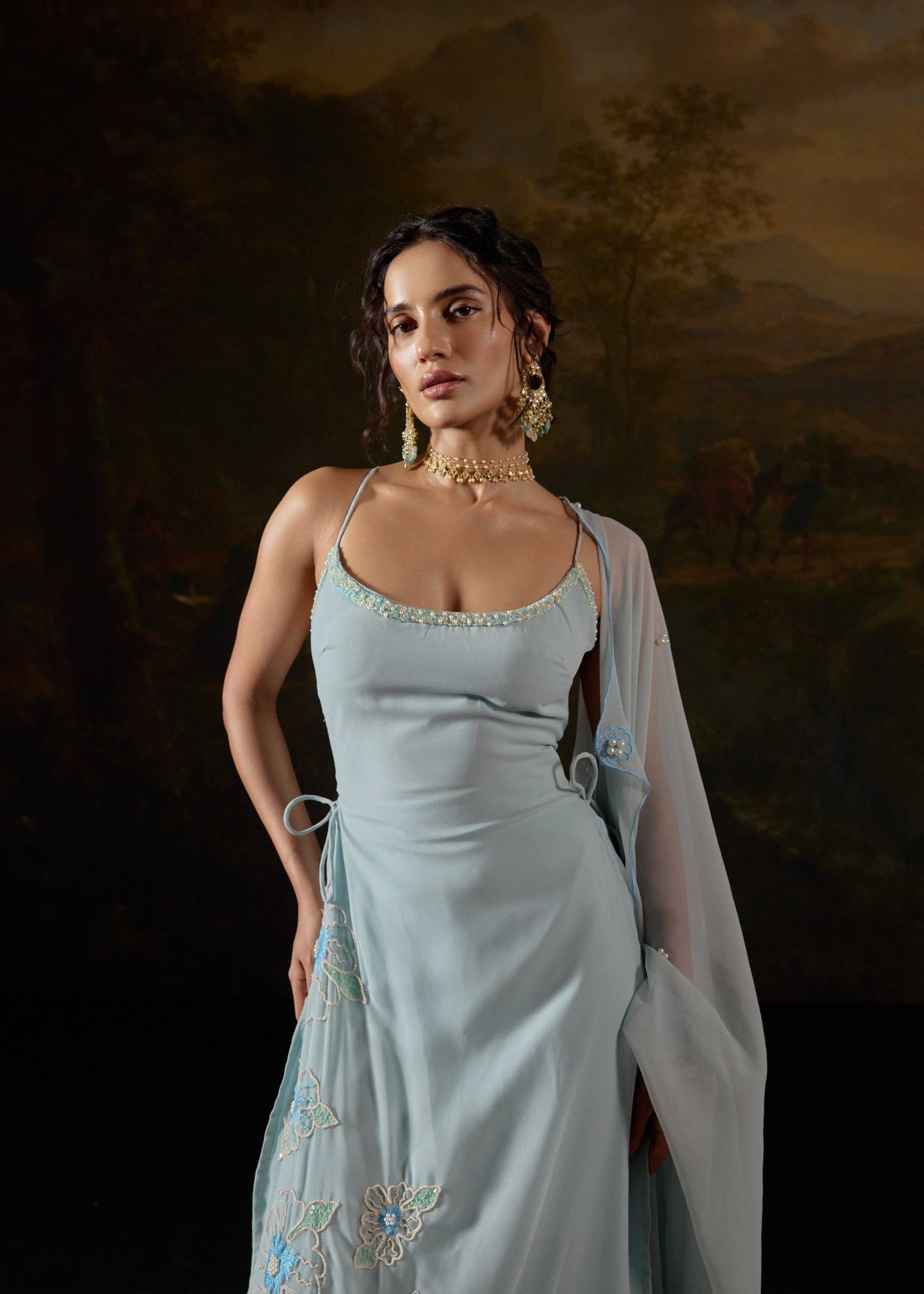 Raaya Baby Blue Hand-Embroidered Sleeveless Suit featuring intricate floral designs and lightweight fabric."