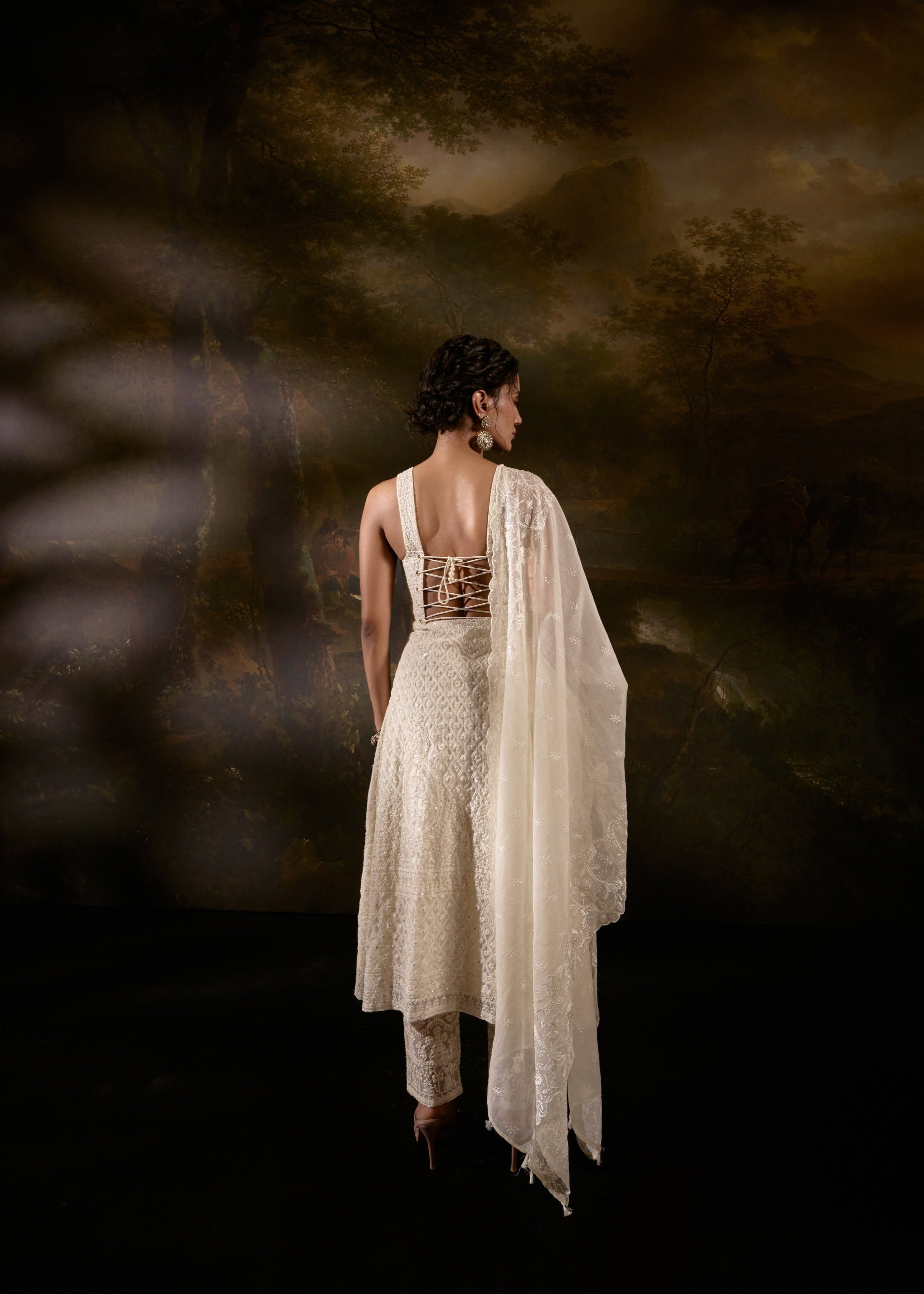 "Sajoon White Organza Chikankari Corset Anarkali Suit Set: Elegant Anarkali suit set in white organza with Chikankari embroidery and a corset design."