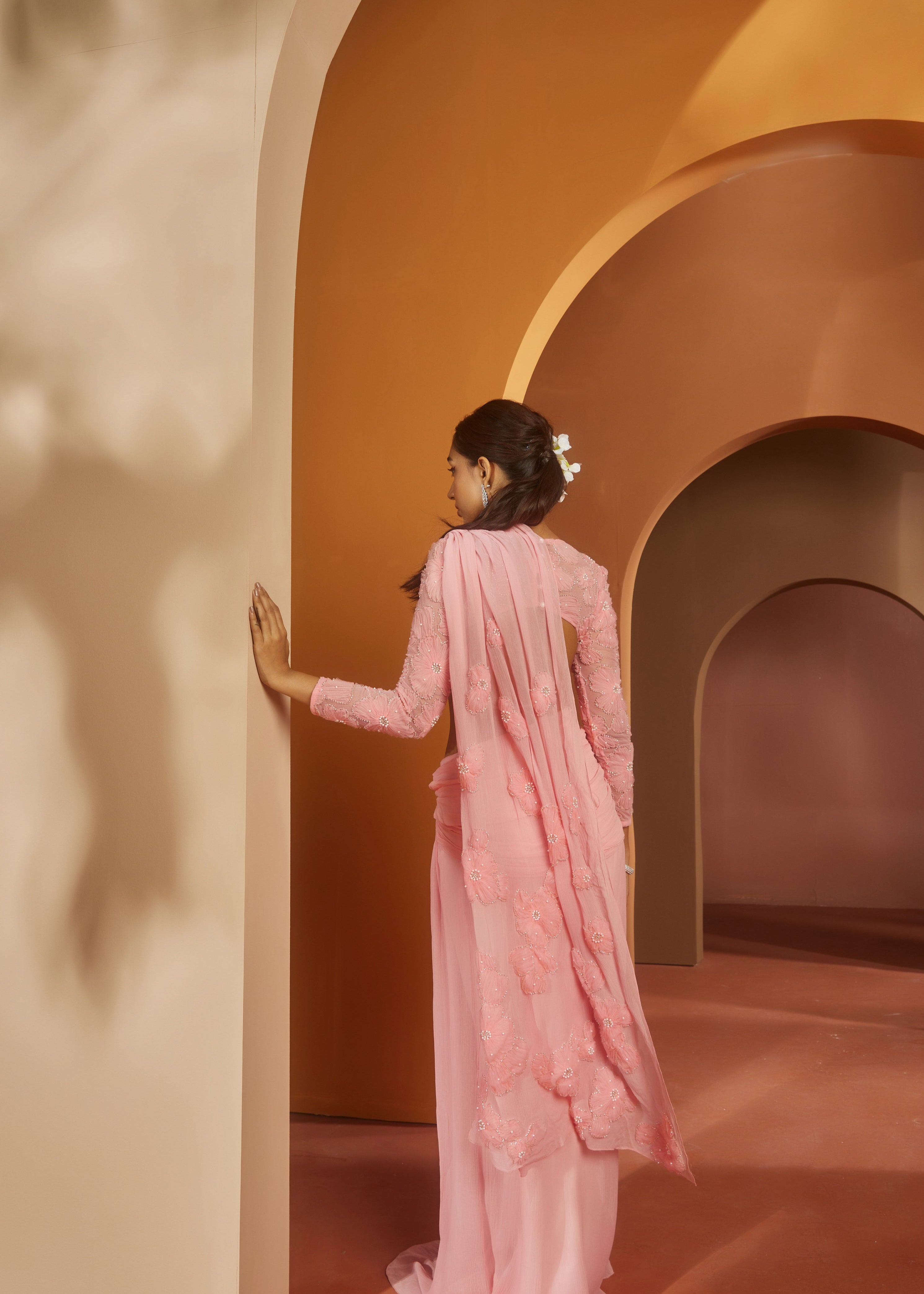 Graceful woman in a Sarika Pink Flower Embroidery Pre-Draped Saree Set, radiating floral elegance and charm