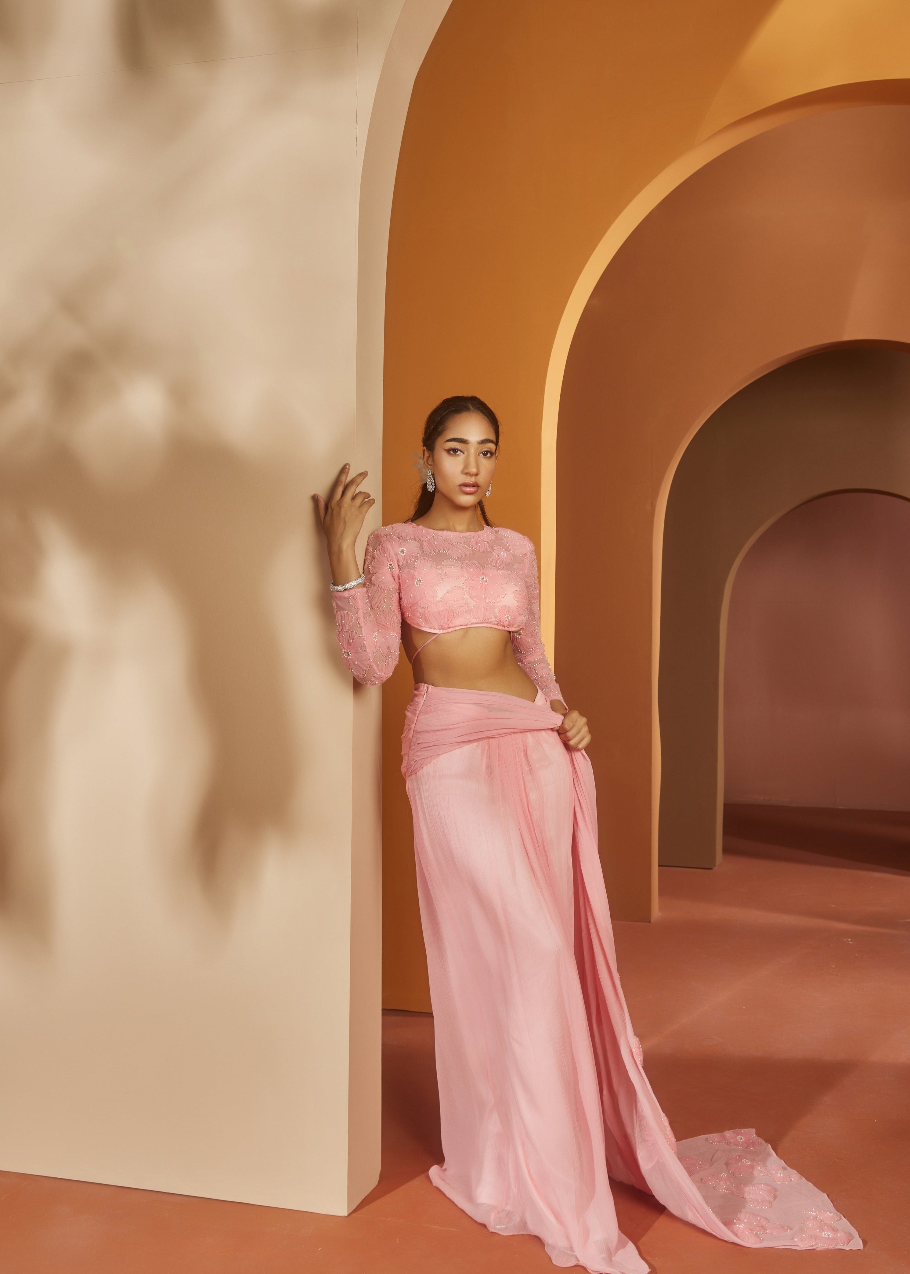 Graceful woman in a Sarika Pink Flower Embroidery Pre-Draped Saree Set, radiating floral elegance and charm