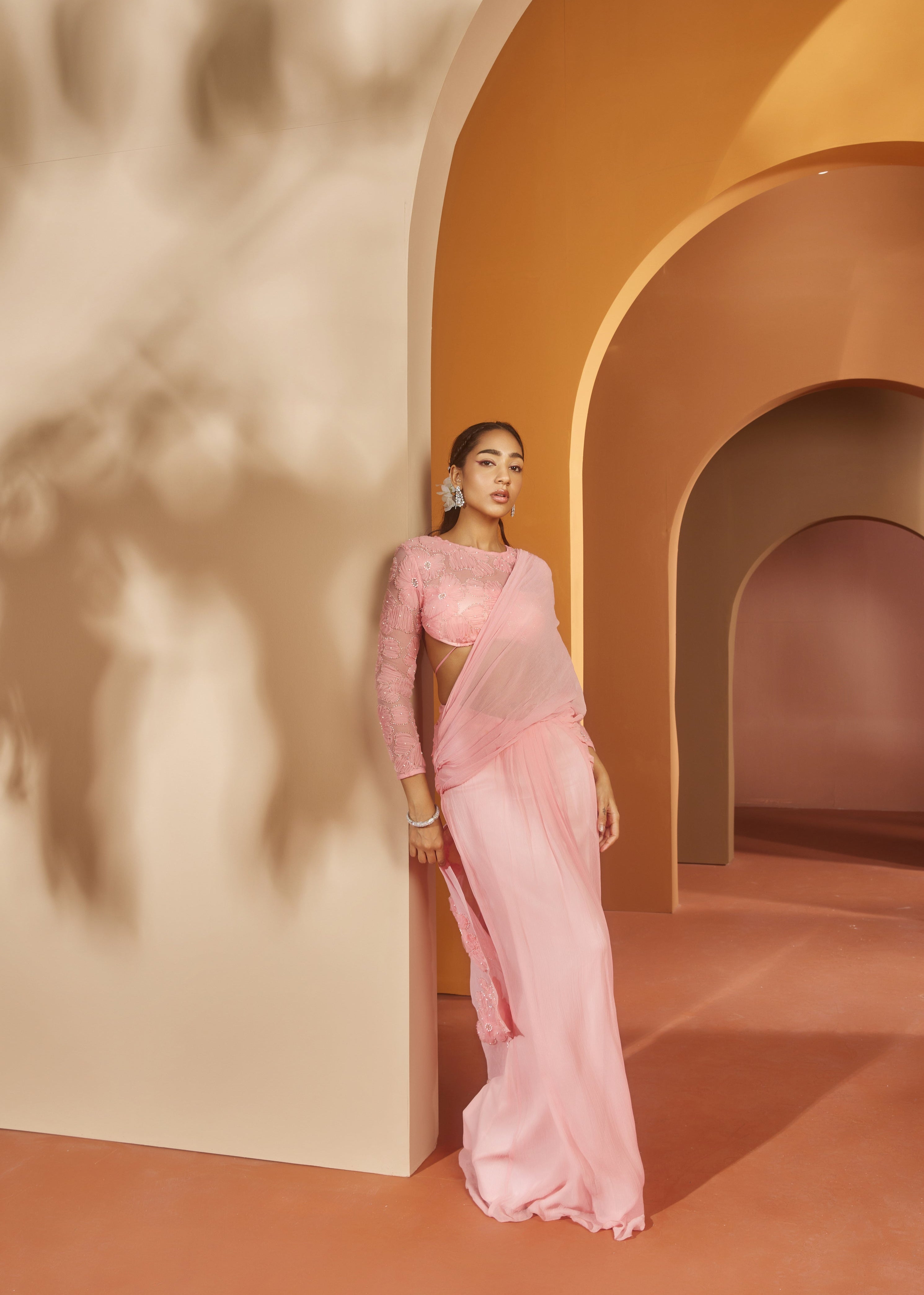 Graceful woman in a Sarika Pink Flower Embroidery Pre-Draped Saree Set, radiating floral elegance and charm