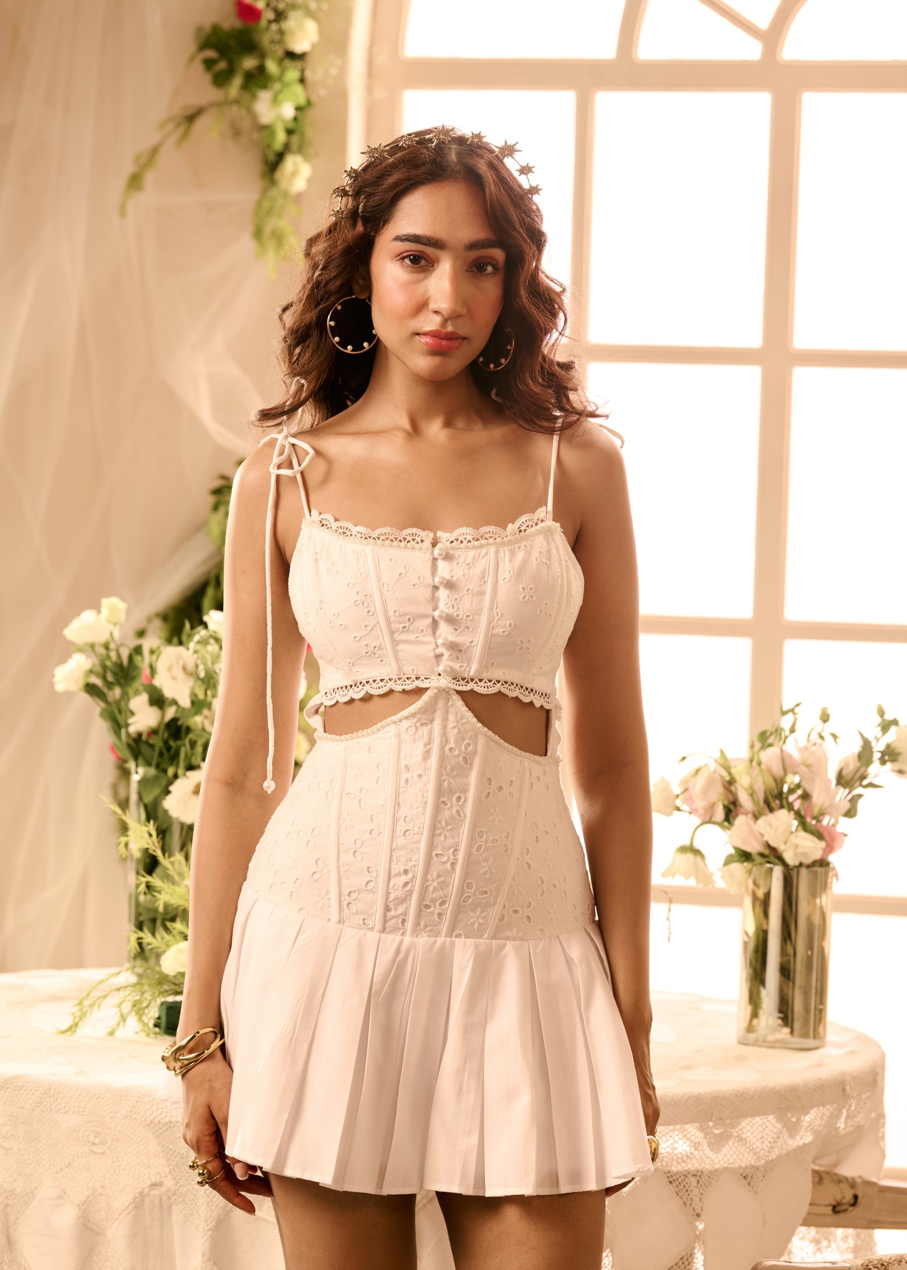 A white mini dress with a corset-style bodice and cutout detailing.