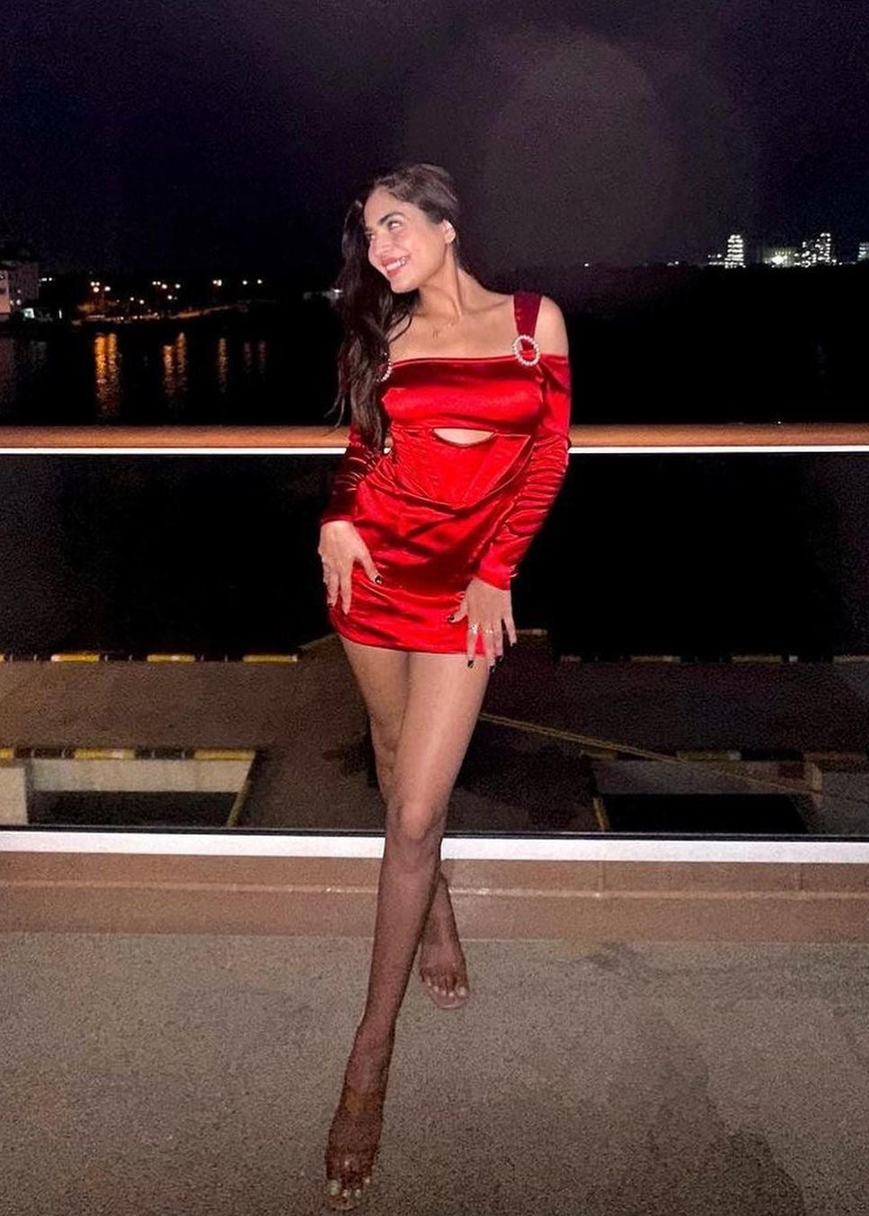 Stylish woman in a Sofia Red Stretch Satin Corset Mini Dress, exuding bold elegance