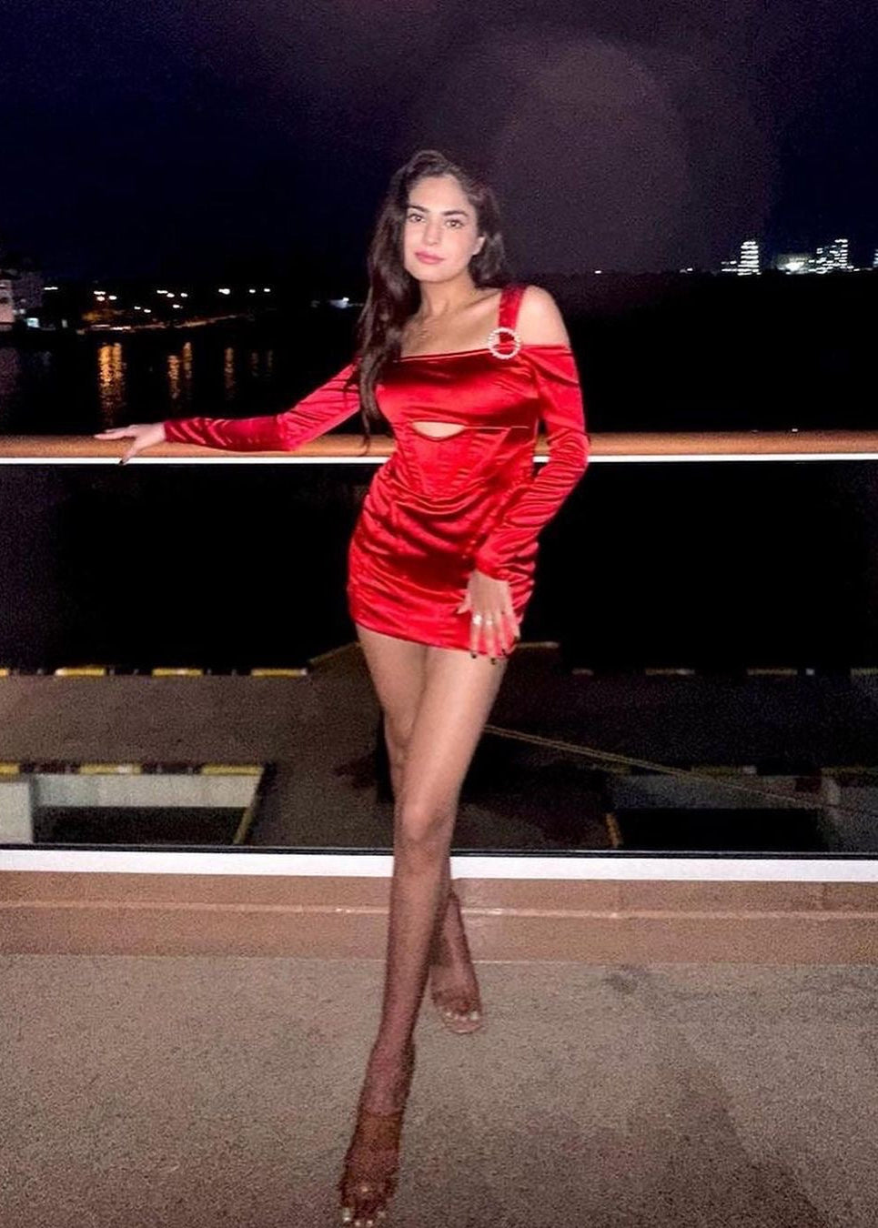 Stylish woman in a Sofia Red Stretch Satin Corset Mini Dress, exuding bold elegance