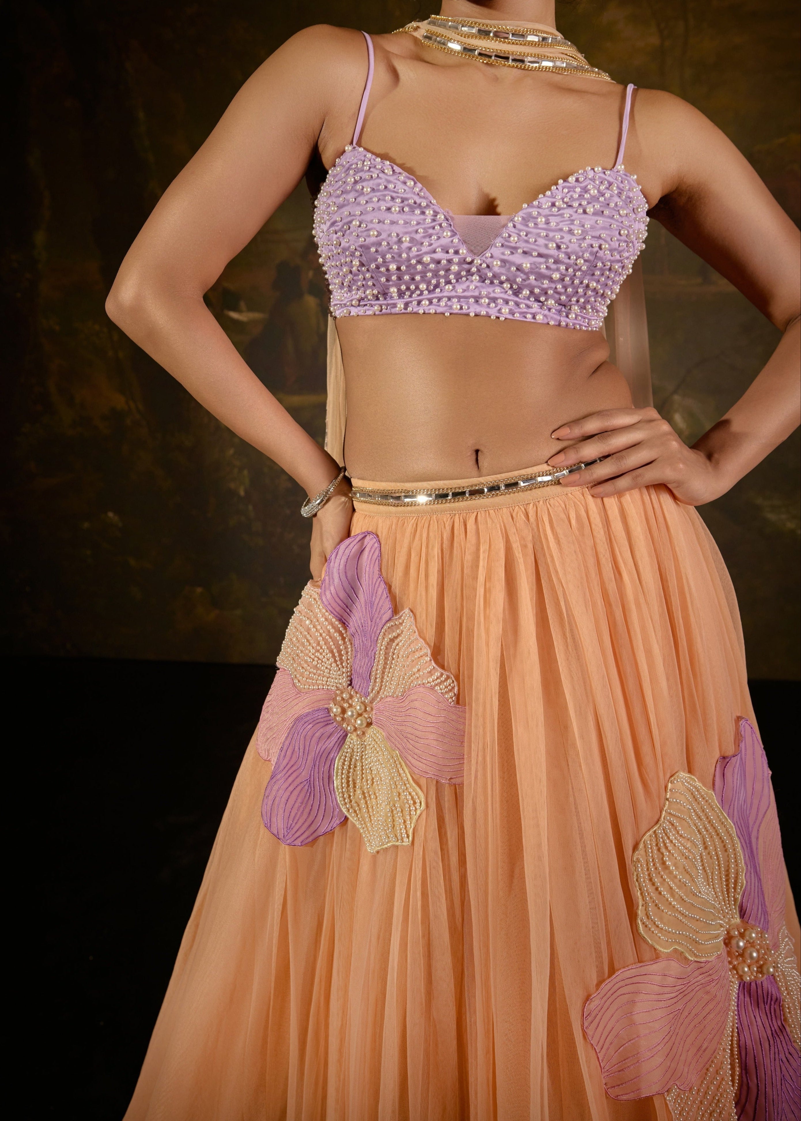 "Tasmeekh Lavender And Orange Embroidered Lehenga Set: Vibrant lehenga set with intricate embroidery in lavender and orange, perfect for a festive look."