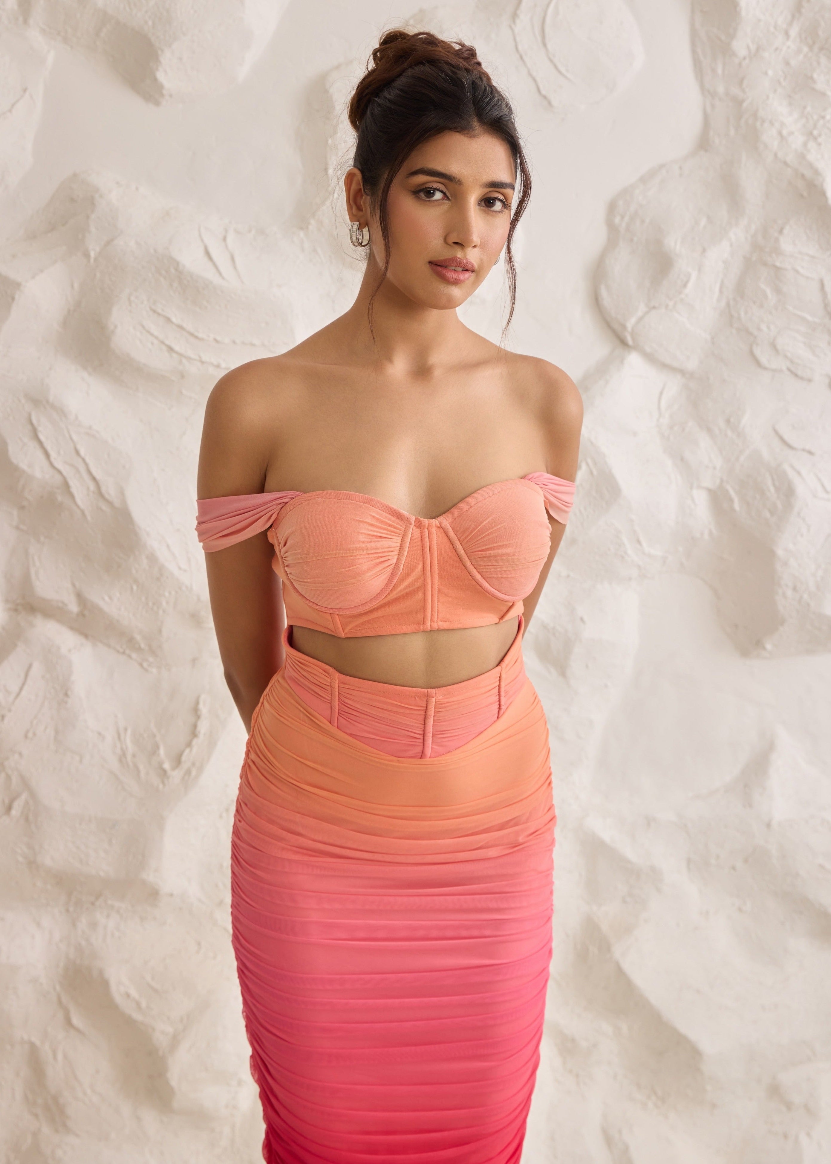A striking Tatiana sunset ombre midi corset dress with ruched detailing for a flattering silhouette.