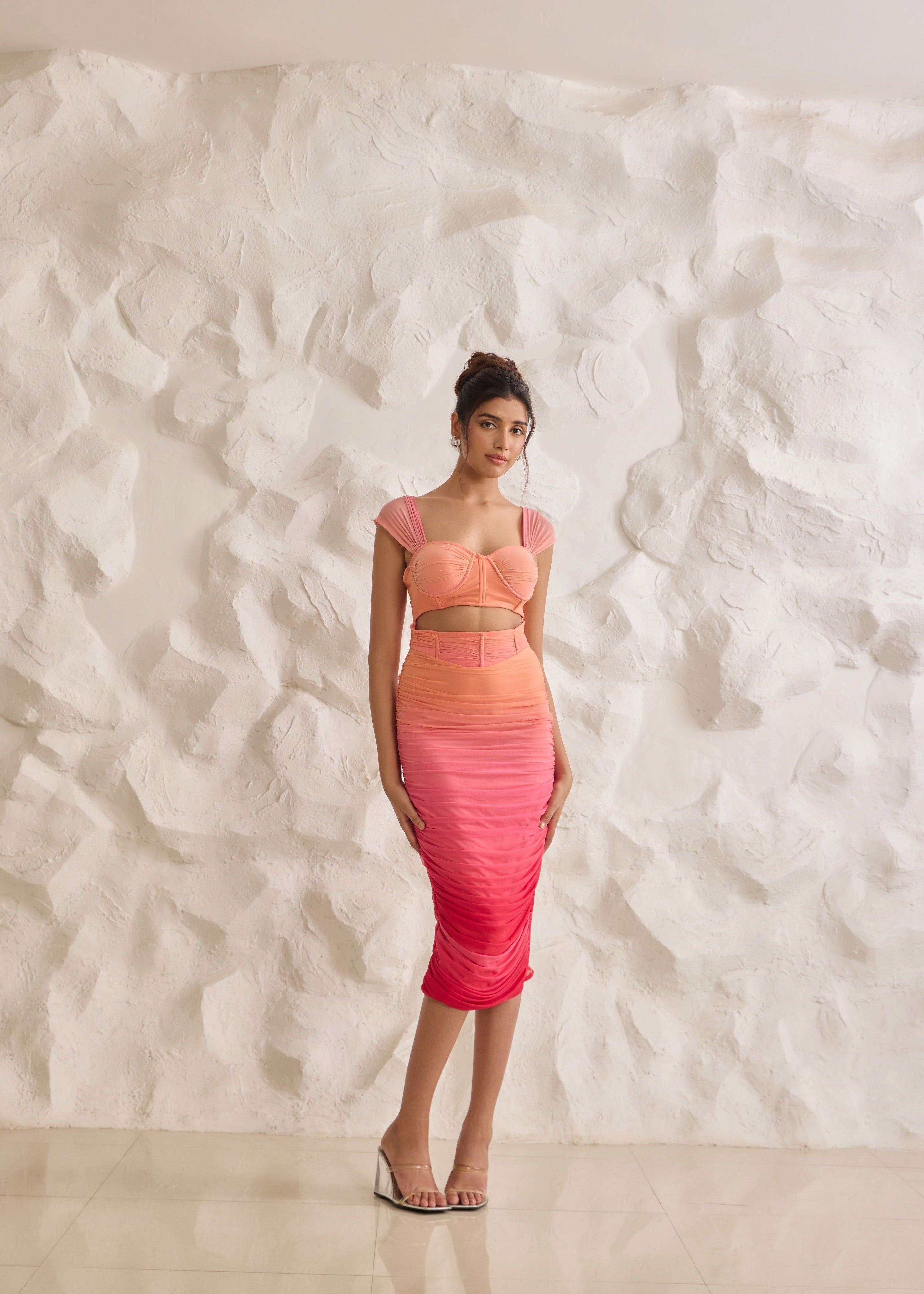 A striking Tatiana sunset ombre midi corset dress with ruched detailing for a flattering silhouette.