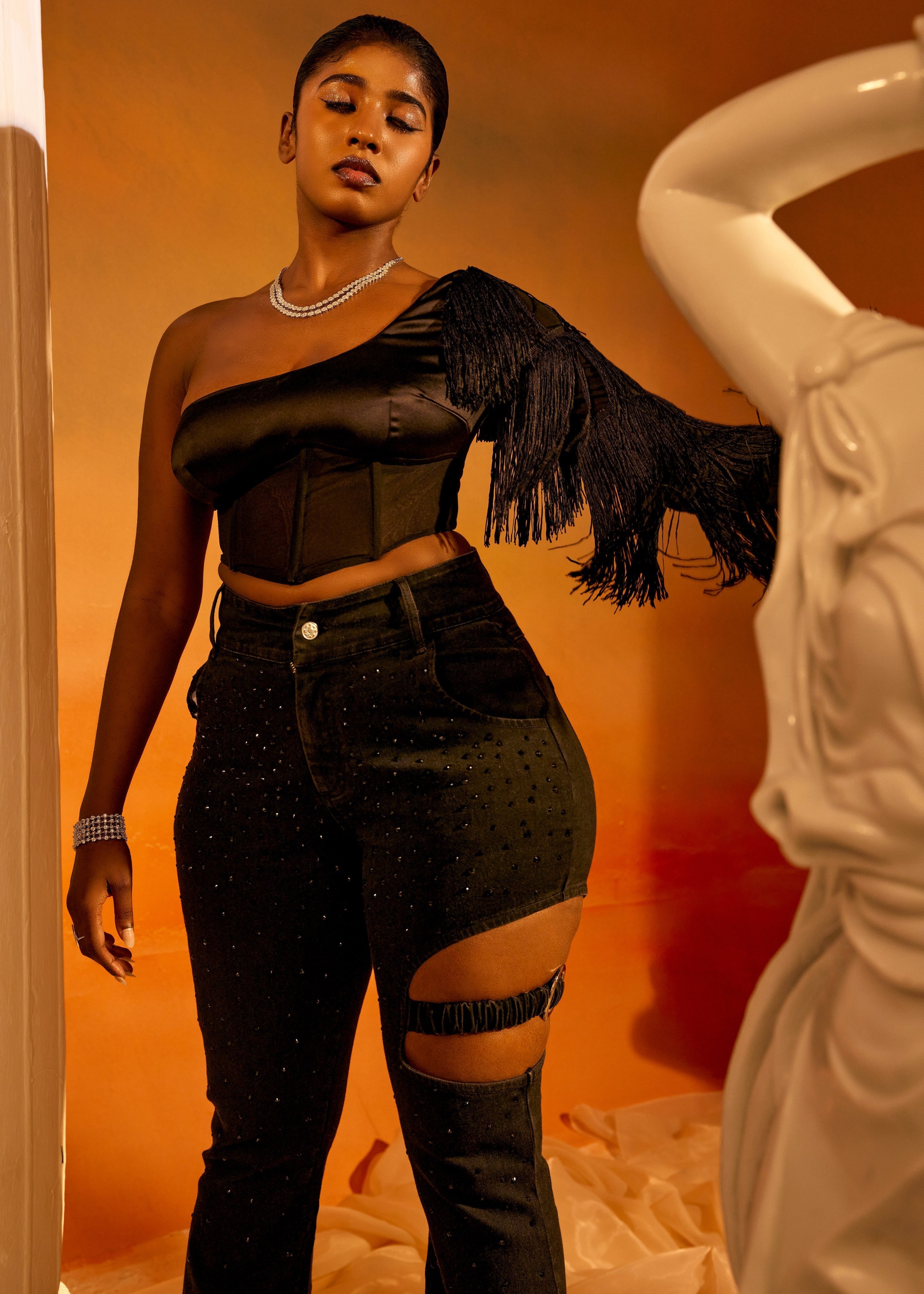 Arabella Black Tassel Sleeve Corset featuring dramatic tassel sleeves and a structured corset design in black